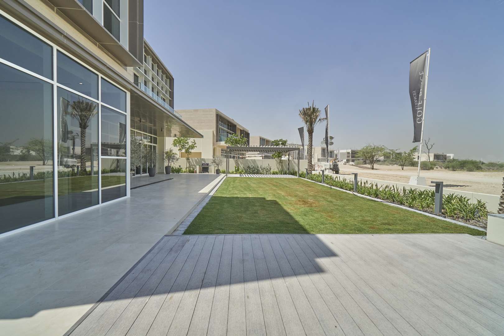 Modern villa exterior with large windows and landscaped garden in Dubai Hills Estate