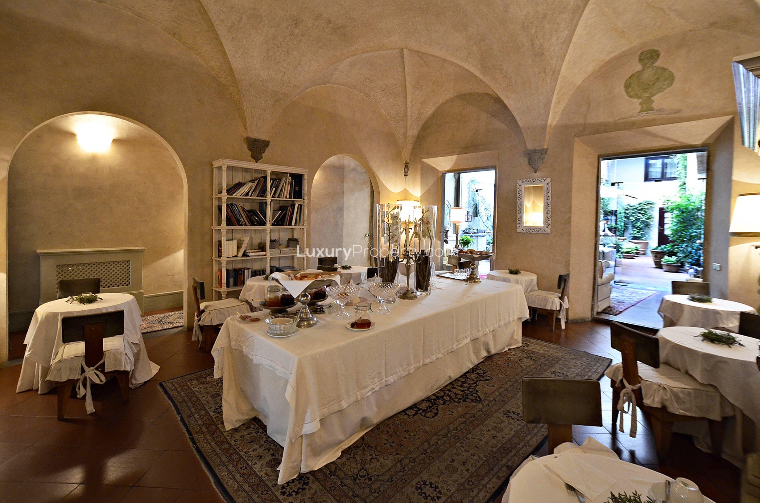 Frescoed walls and ornate mirror in charming 19-bedroom hotel near Piazza Santa Croce, Florence