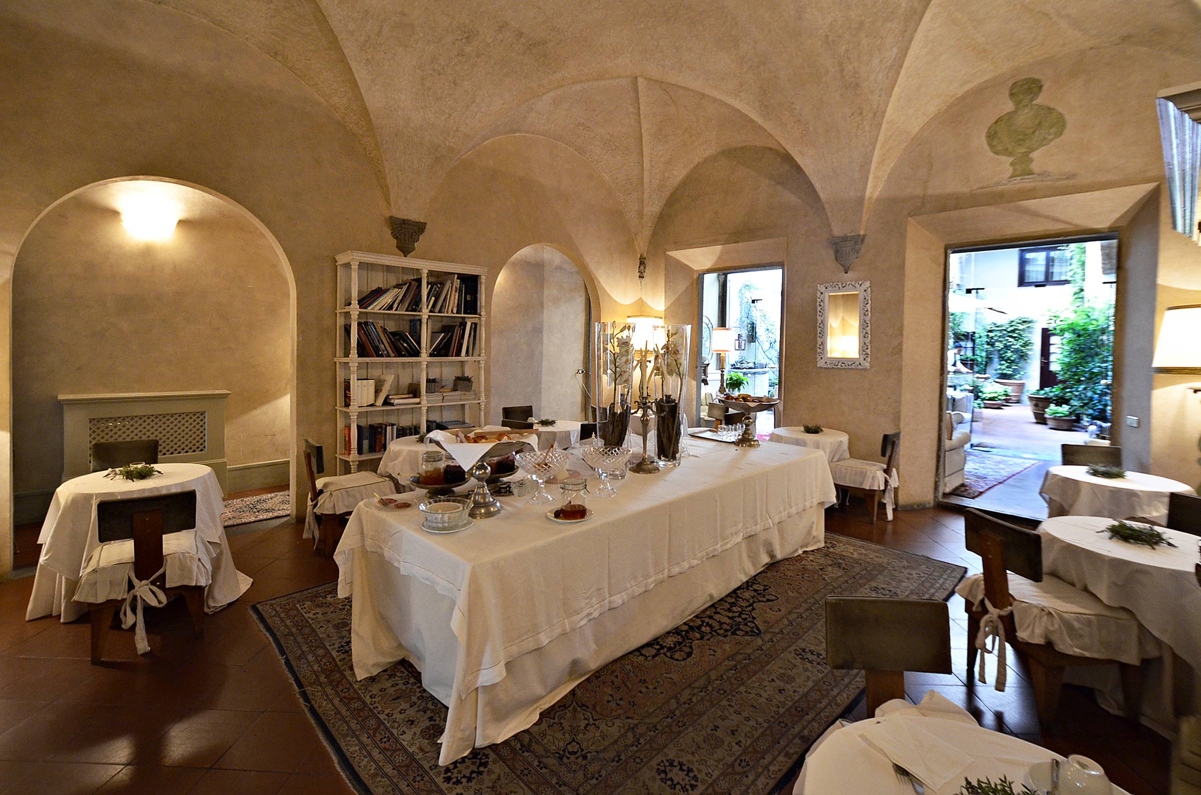Frescoed walls and ornate mirror in charming 19-bedroom hotel near Piazza Santa Croce, Florence