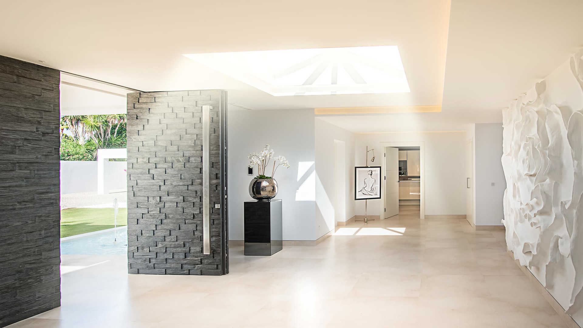 Modern interior of beachfront villa in Marbella, featuring elegant wall art and skylight