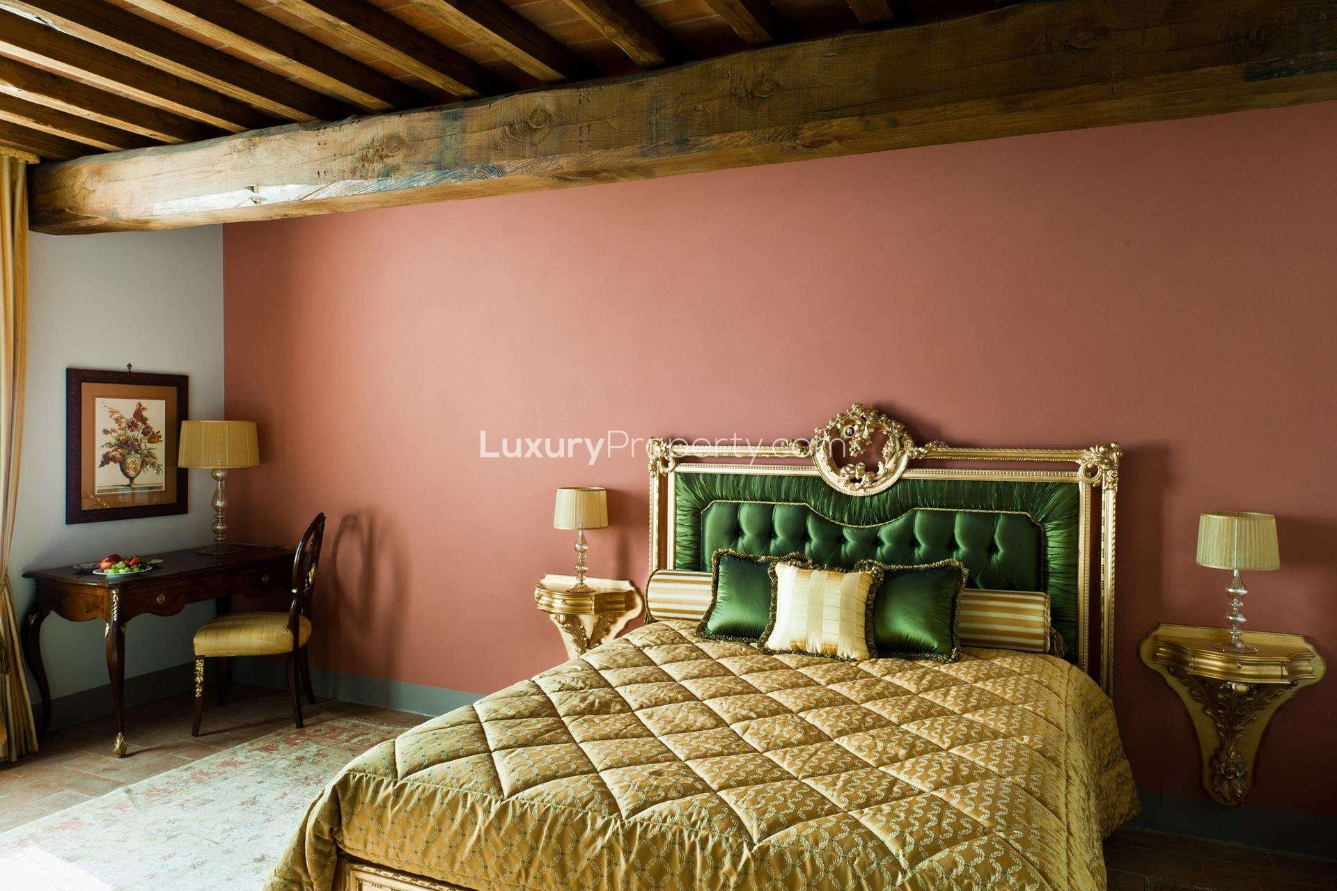Luxurious Siena villa bedroom with rustic beams and elegant decor in boutique hotel style