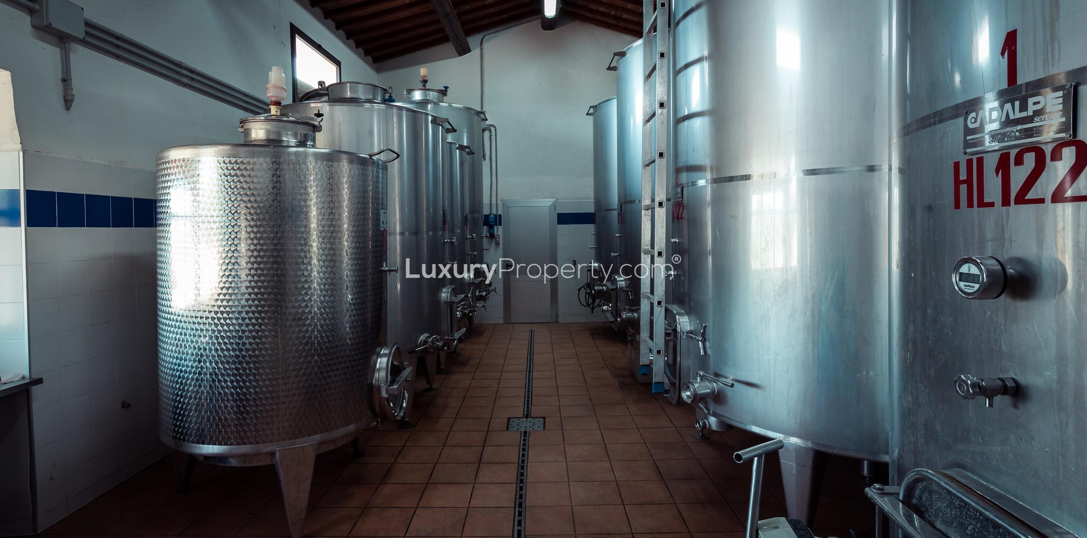 Wine cellar with oak barrels in Tenuta La Favola, Florence Tuscany villa for sale