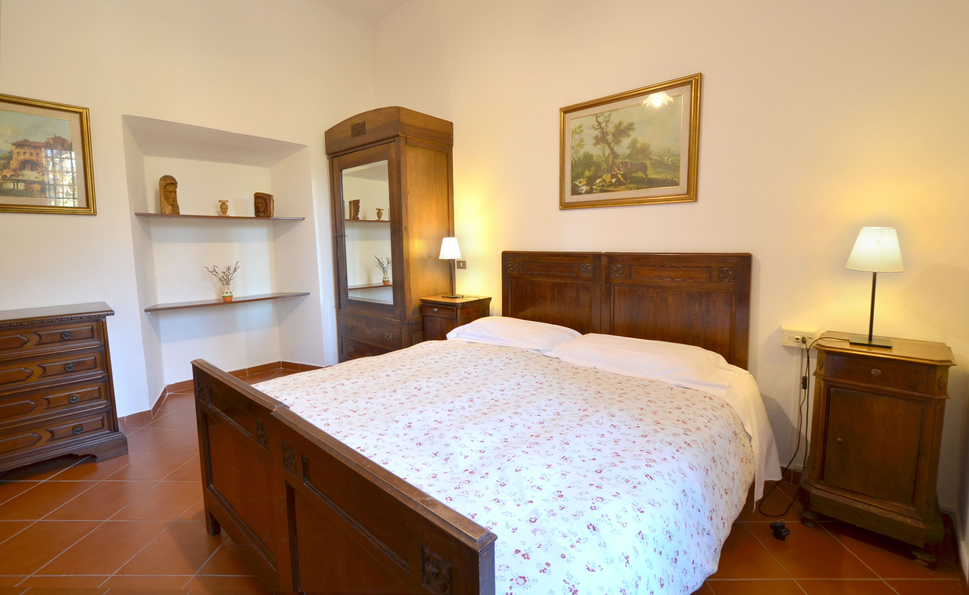 Cozy bedroom in Florence villa, featuring rustic wooden furniture and elegant decor