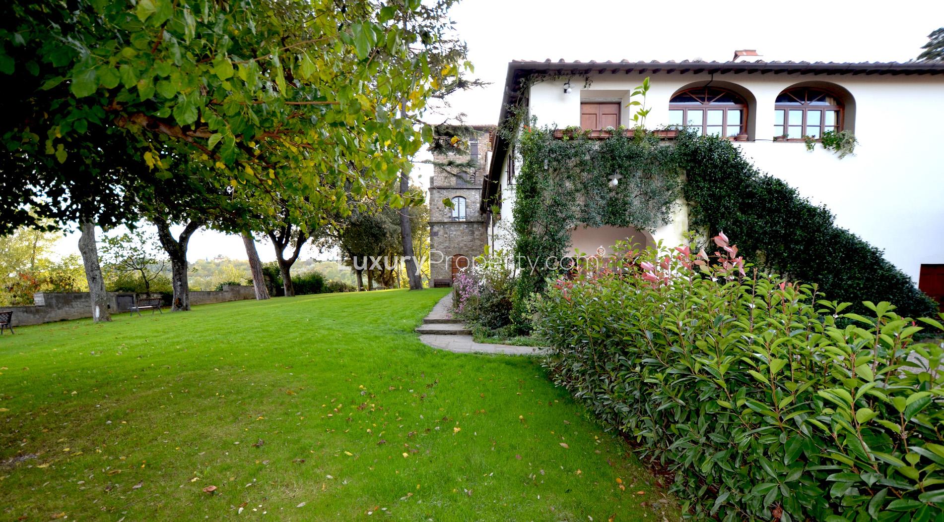 Gorgeous villa exterior with medieval tower in lush garden, Torre Bella Vista, Florence