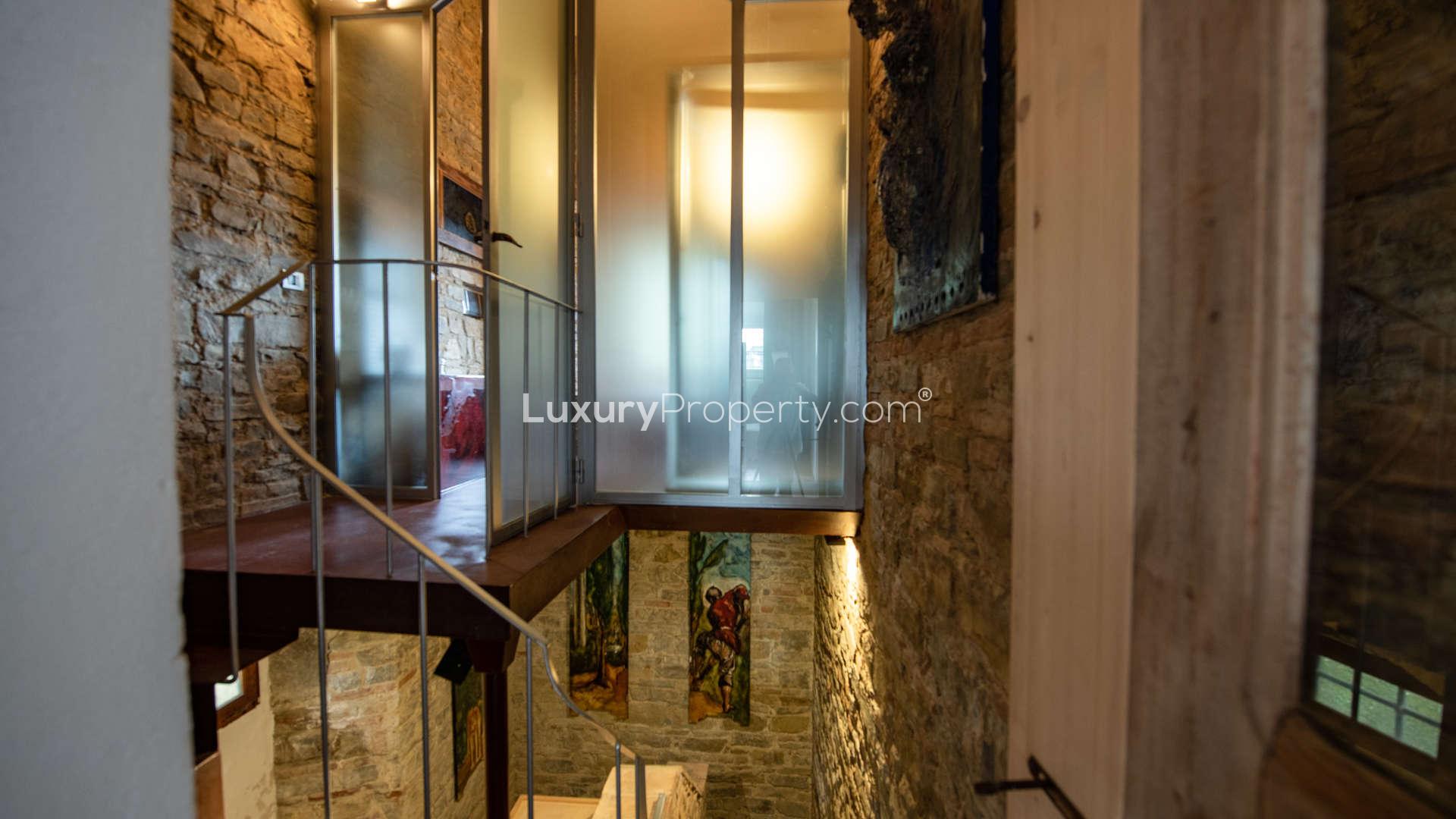 Luxurious living room in 16th-century Tuscan villa, featuring elegant decor and piano