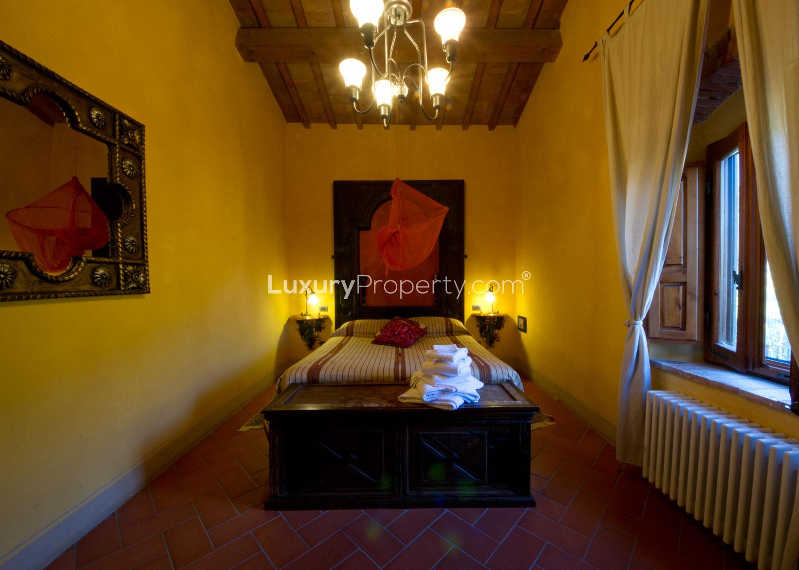 Rustic wine cellar with barrels and dining setup in Villa Panorama, Florence