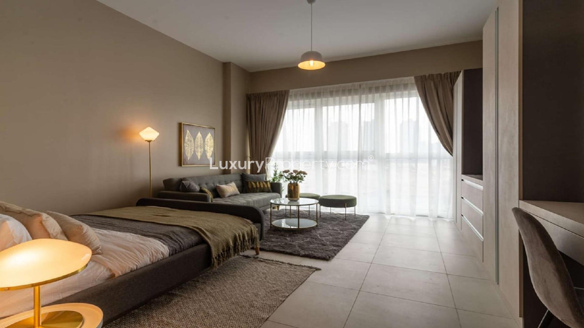 Fully furnished studio apartment interior at Olivara Residences, Dubai Studio City