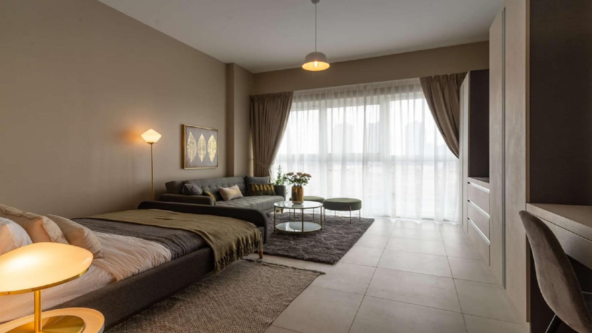 Fully furnished studio apartment interior at Olivara Residences, Dubai Studio City