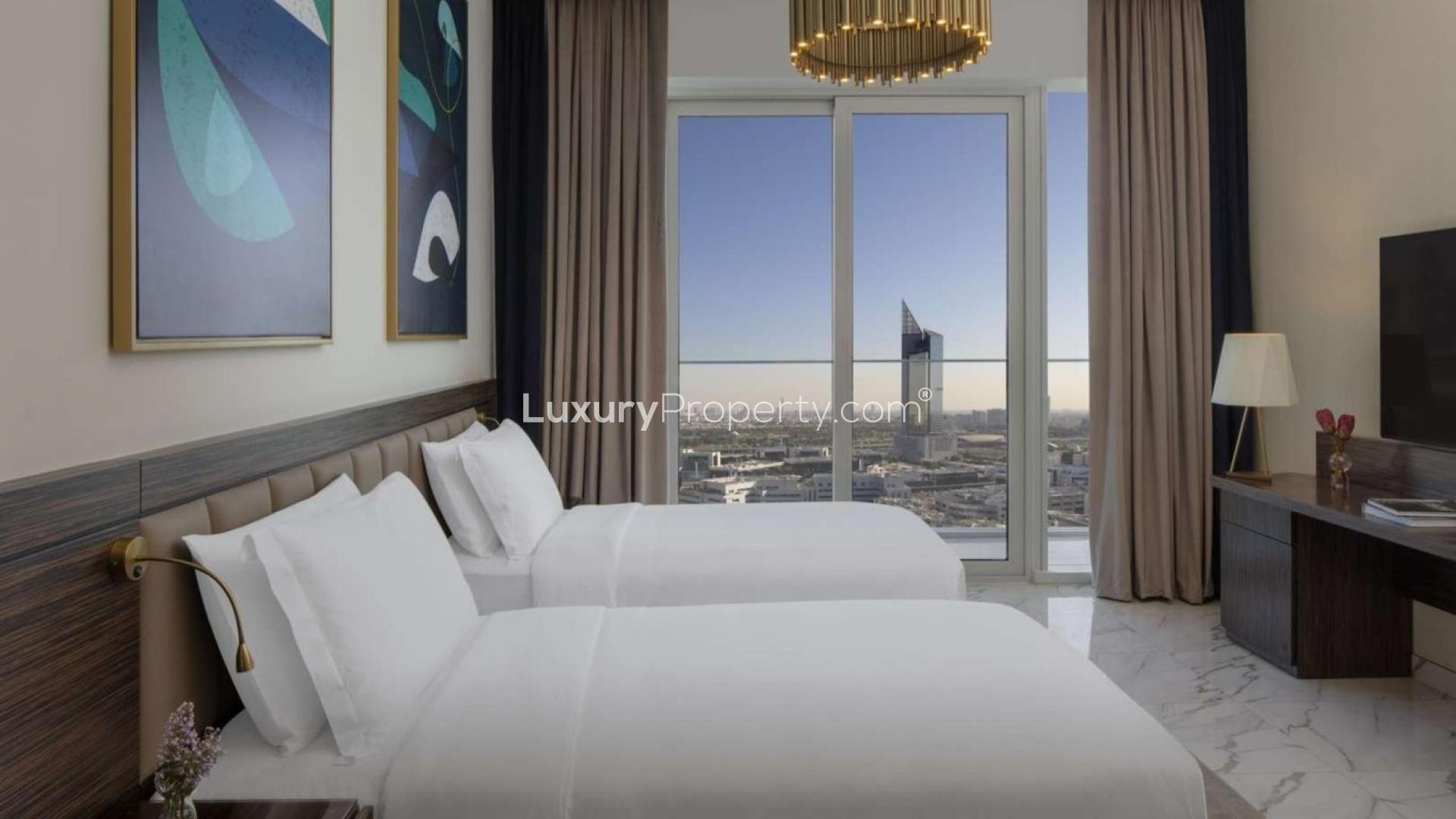 Studio apartment bedroom with twin beds, modern decor, and city view at Avani Palm View