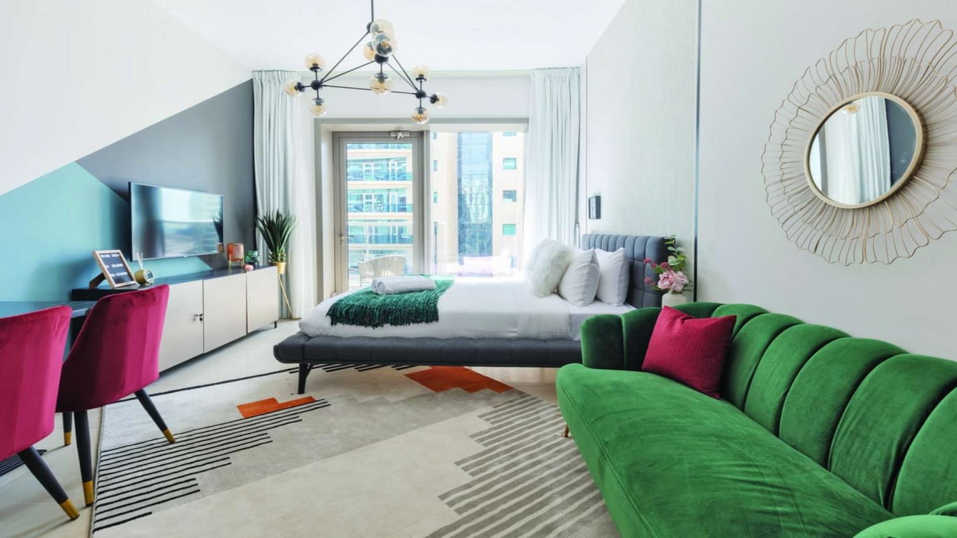 High-floor studio apartment interior in Sparkle Towers, Dubai Marina, modern decor, large window