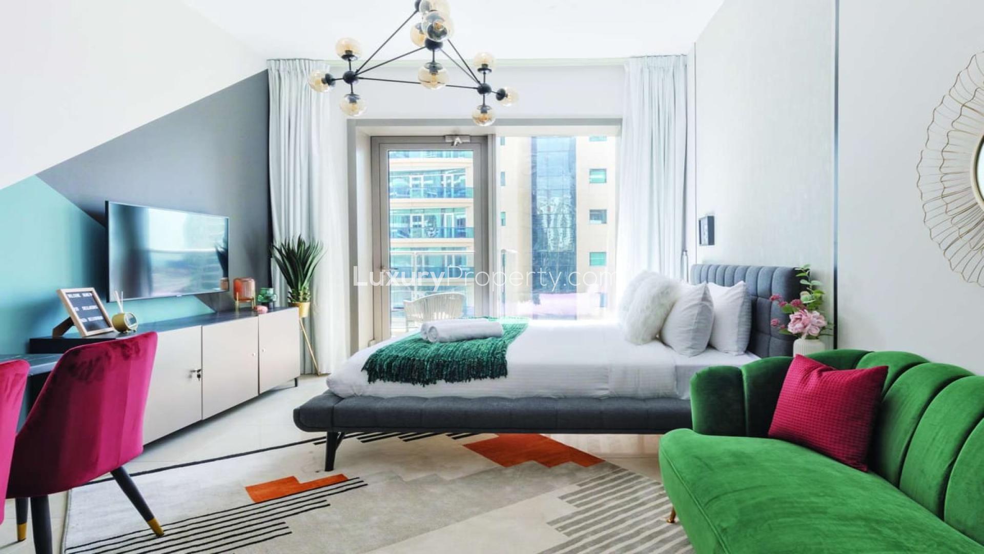 Spacious studio interior in Sparkle Towers, Dubai Marina, with modern decor and kitchen area