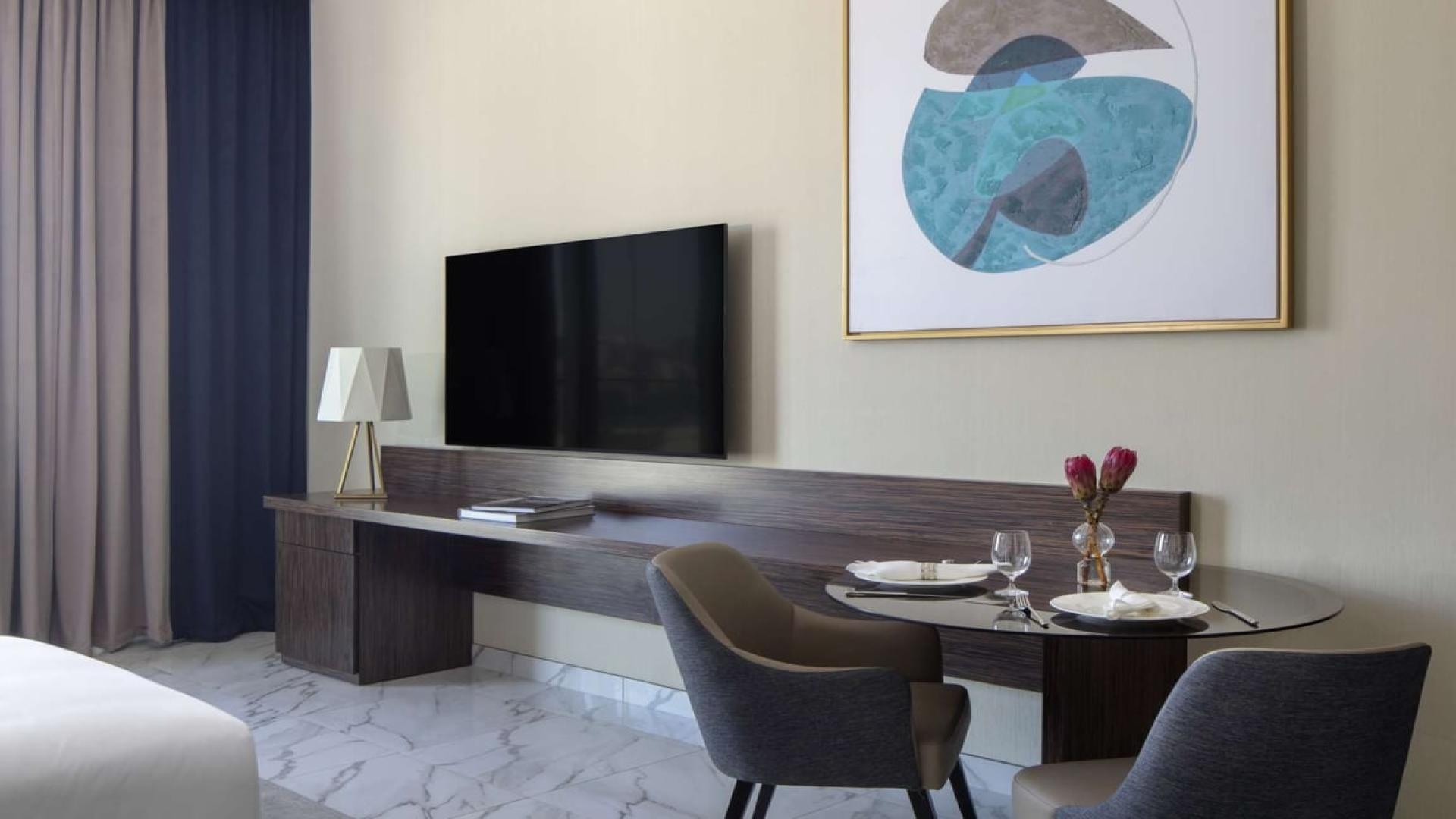 Modern studio apartment interior at Avani Palm View, Dubai Media City, with dining area