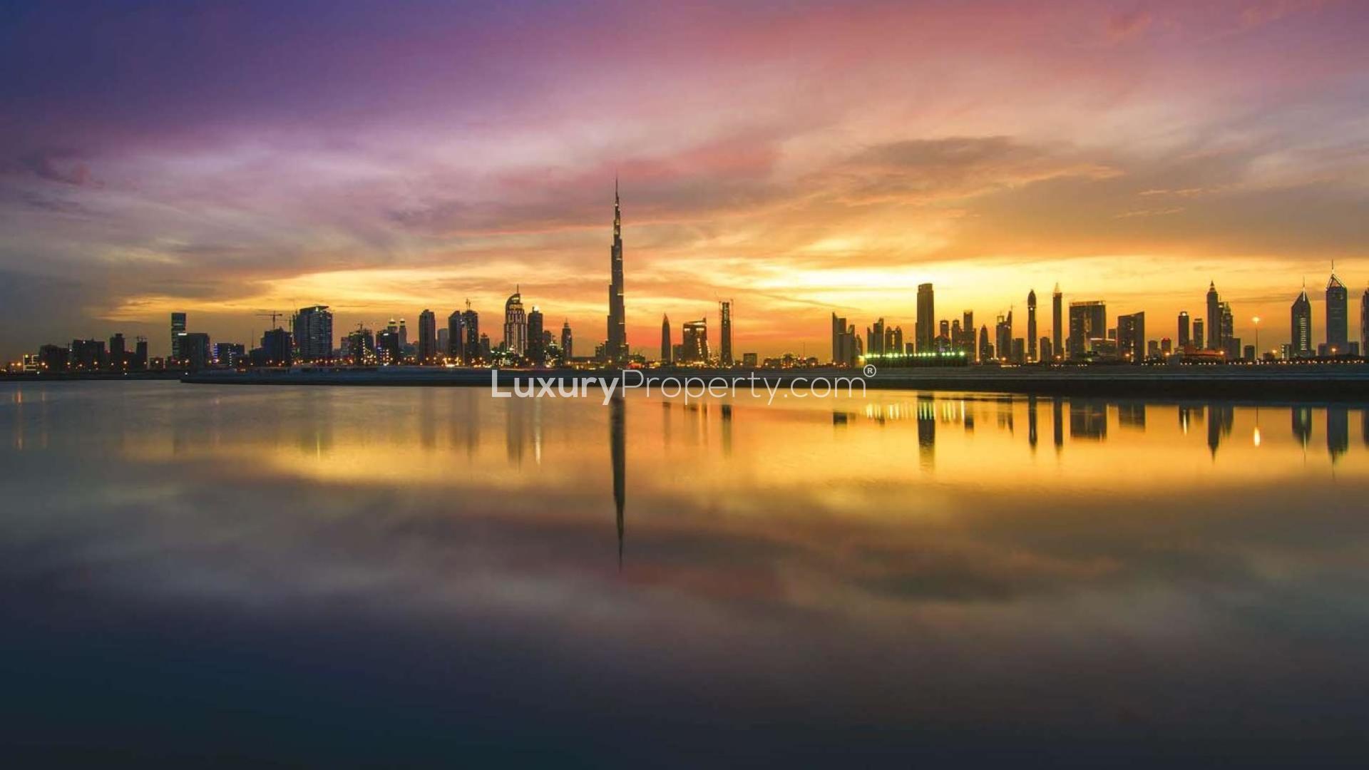 Luxury beachfront apartment community at sunset in Marsa Meydan, Jabel Ali, with marina views