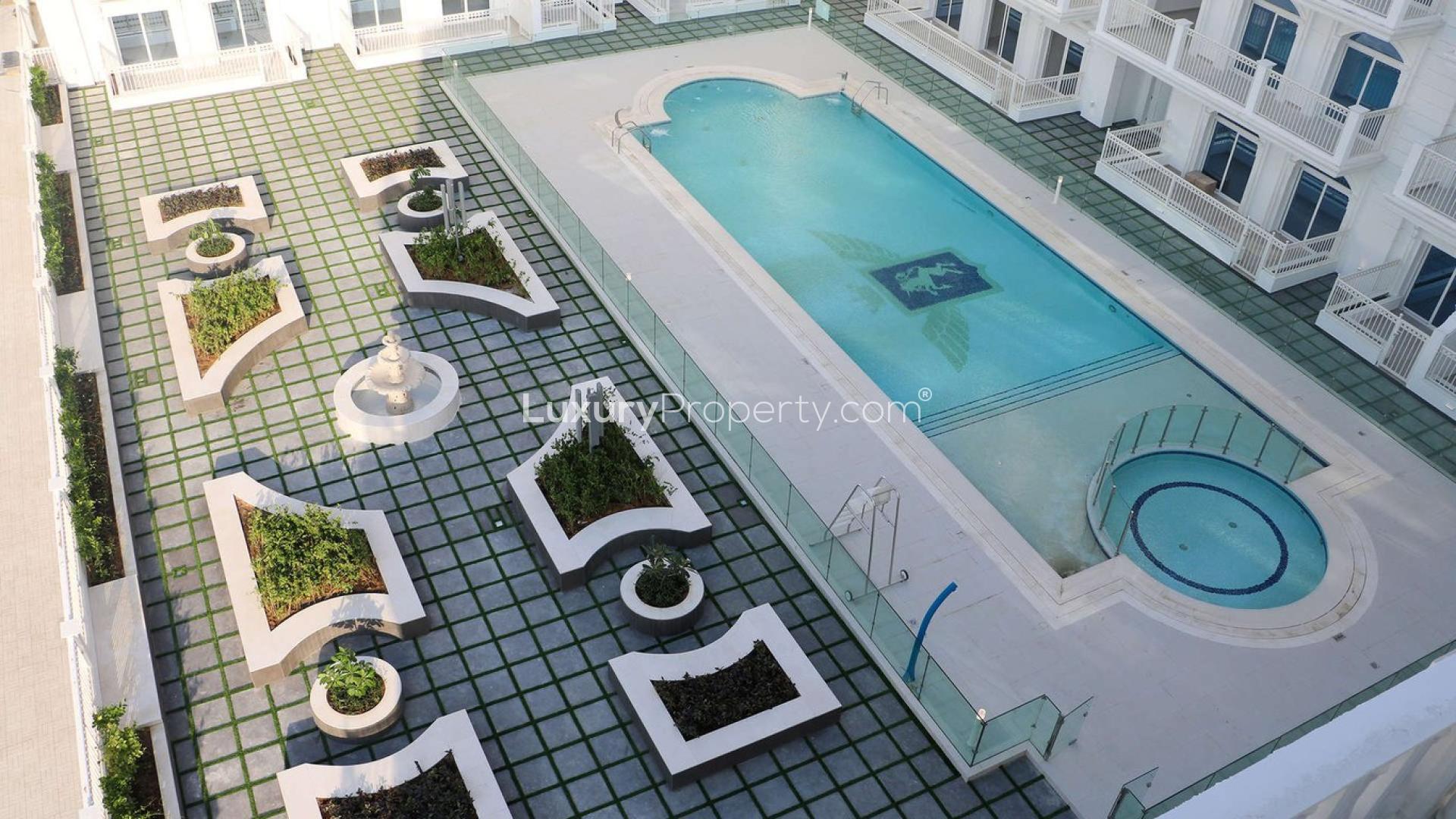 Elegant hallway in Vincitore Palacio, Arjan apartment building, featuring modern elevator and decor