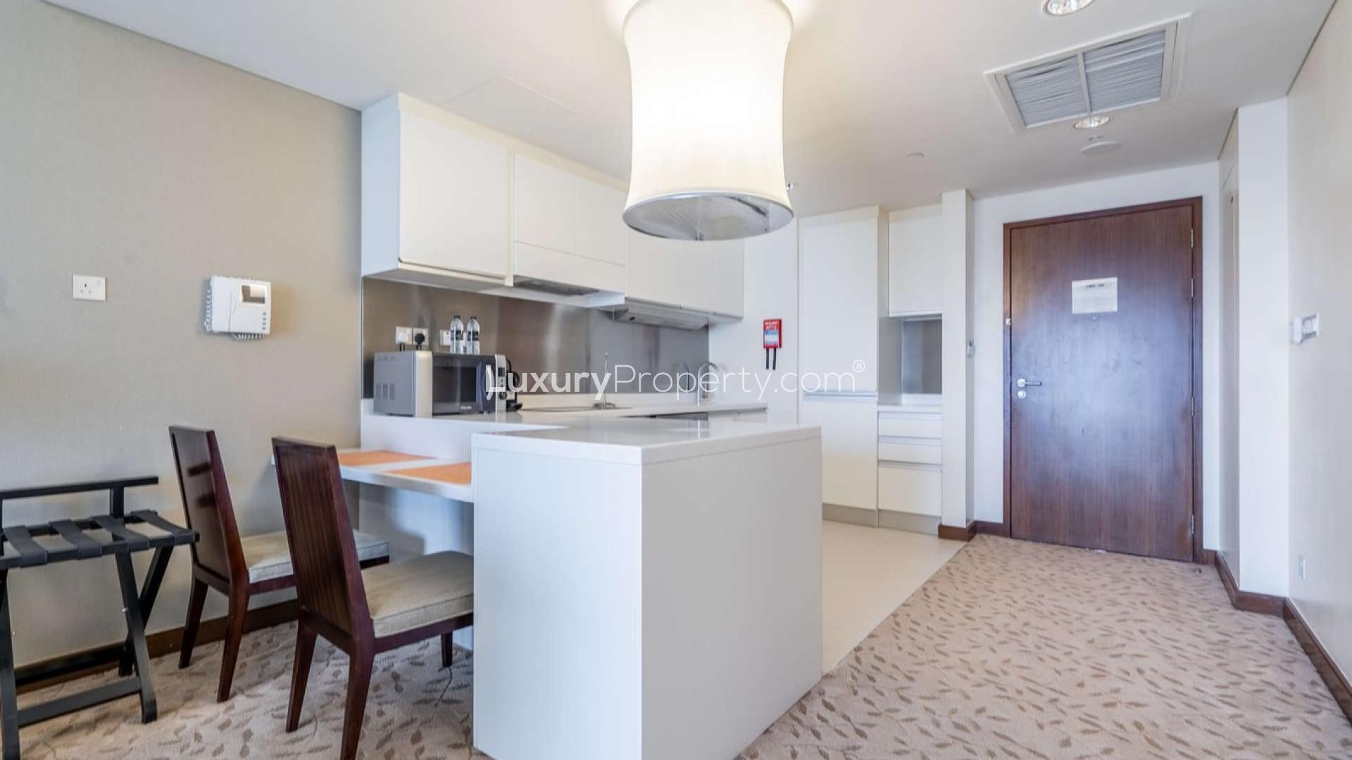 Modern kitchen and living area in Downtown Dubai apartment with Burj Khalifa views