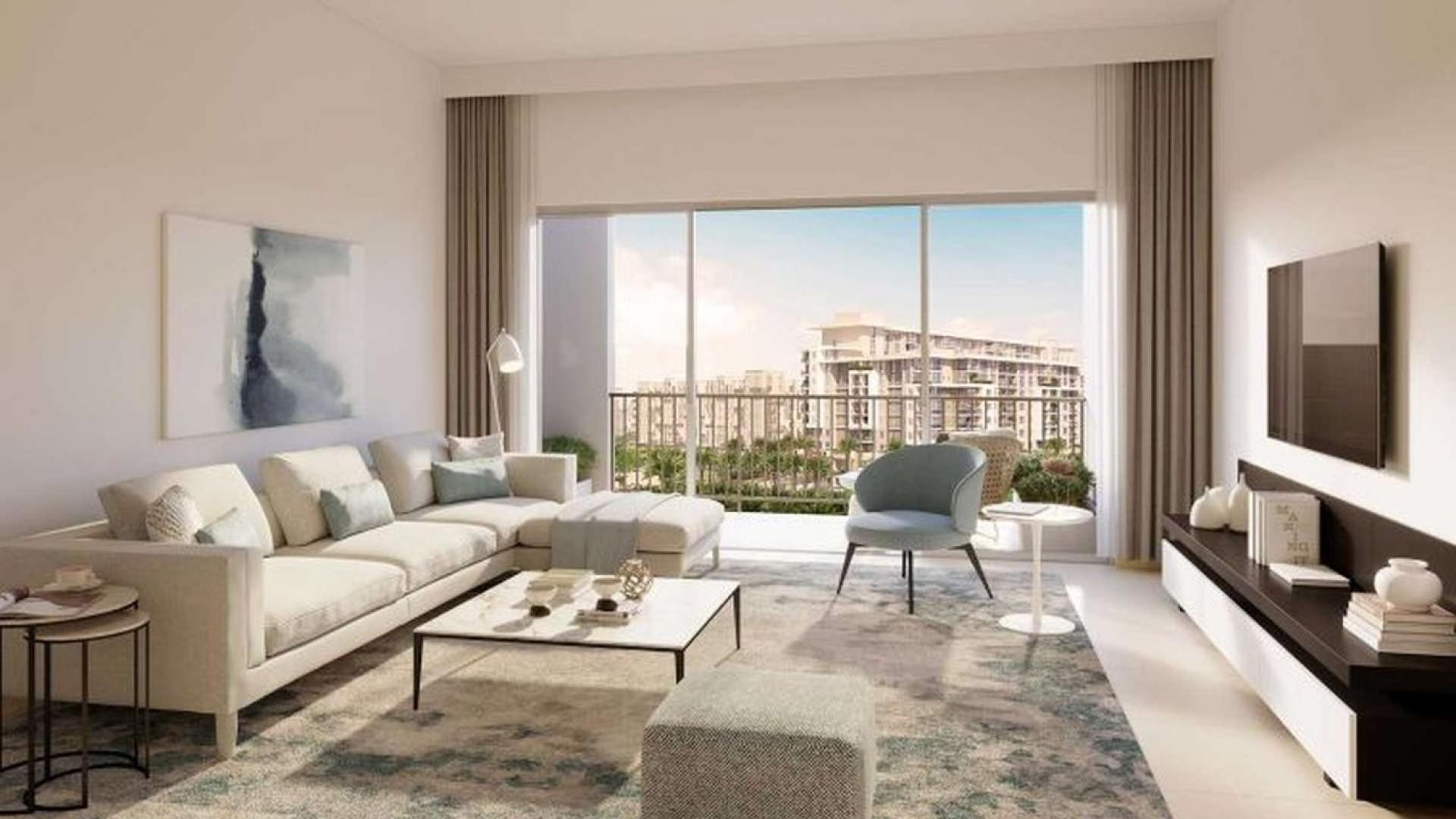 Modern exterior view of Rawda Apartments in Dubai Town Square, surrounded by palm trees