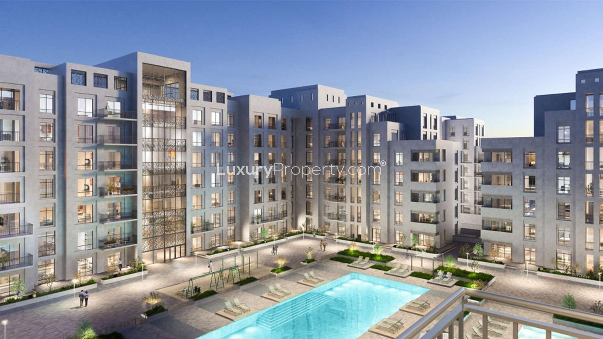 Modern Zahra Apartments exterior with pool view in Dubai Town Square for sale