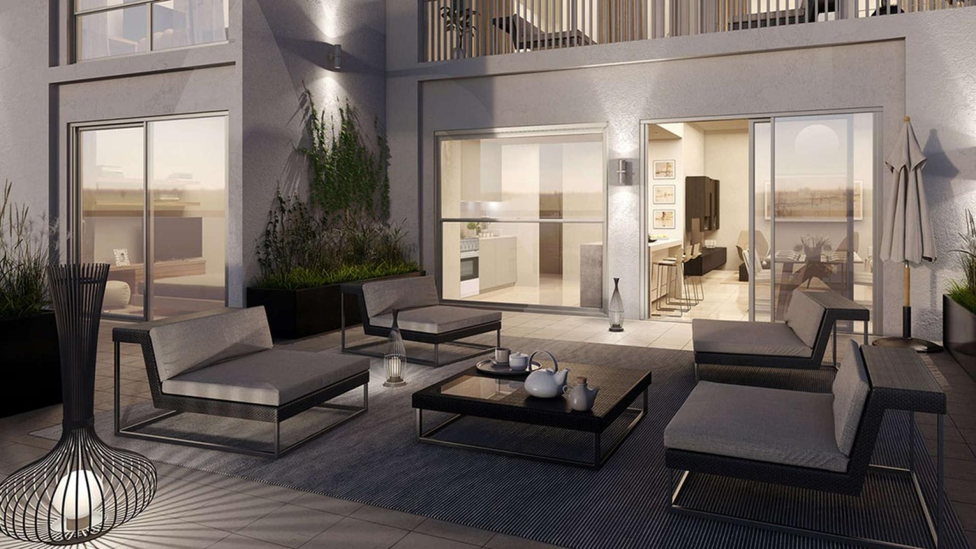 "Luxury Safi Apartments exterior view with pool, Town Square Dubai, studio for sale.",Outdoor seating area at Safi Apartments, Town Square Dubai, for sale, studio apartment