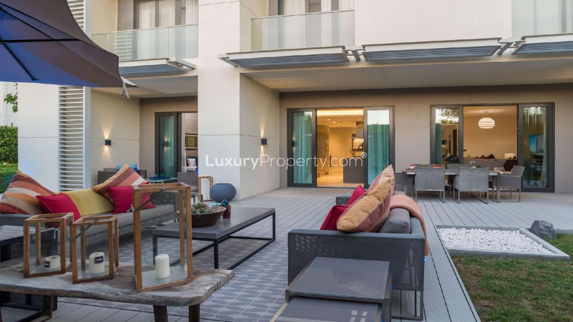 Courtyard view of Sobha Hartland studio apartment with outdoor seating, Mohammed Bin Rashid City