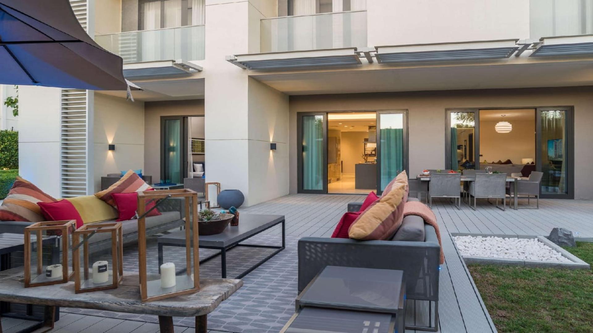 Courtyard view of Sobha Hartland studio apartment with outdoor seating, Mohammed Bin Rashid City