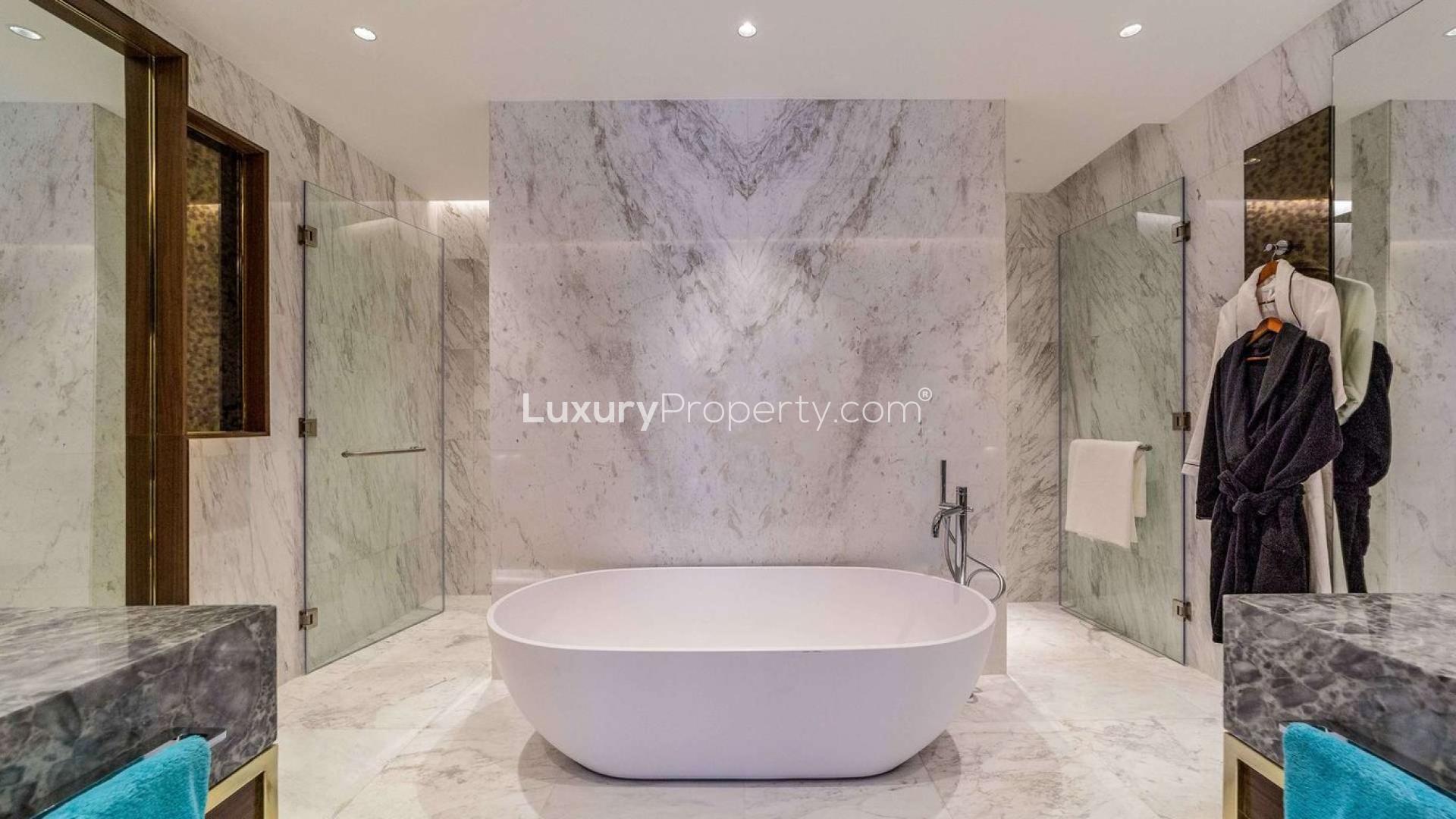 Modern kitchen and living area in Majestic Suite, Langham Place, Downtown Dubai apartment