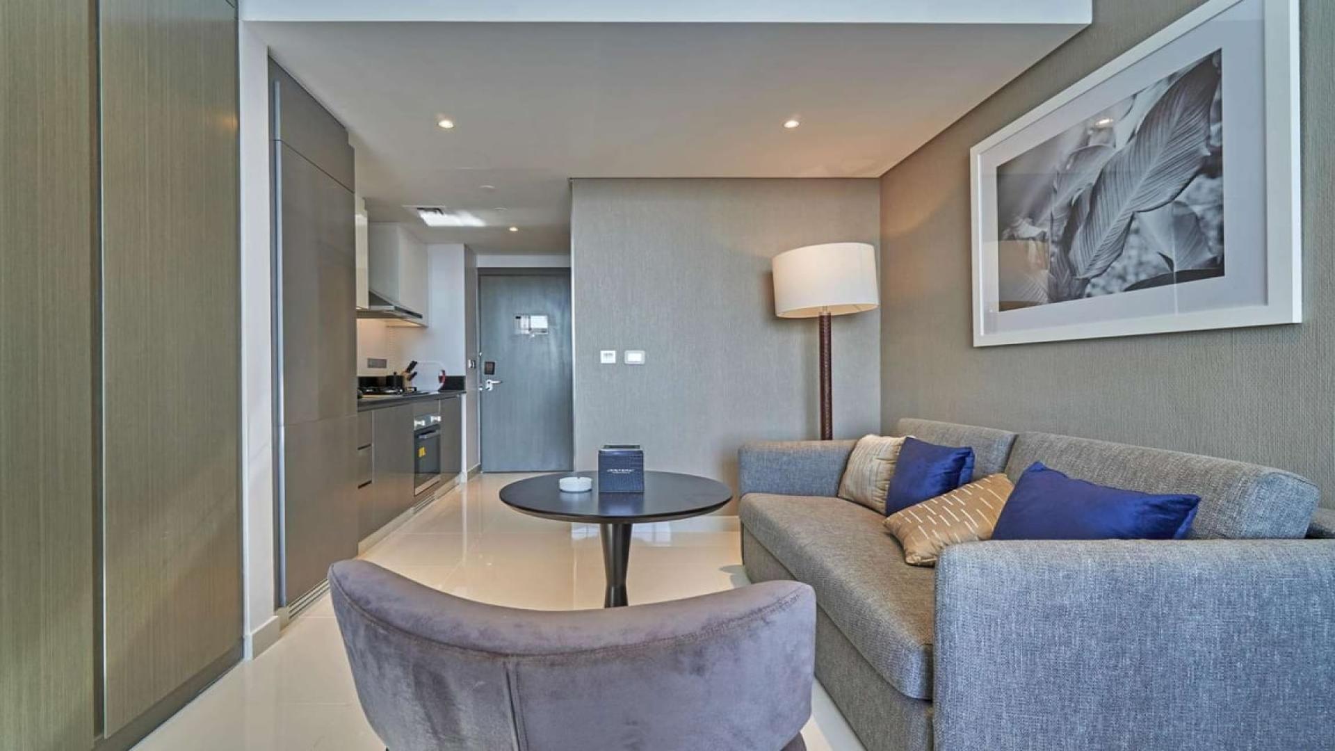 Furnished studio apartment interior in Damac Maison Prive, Business Bay, featuring cozy bedroom