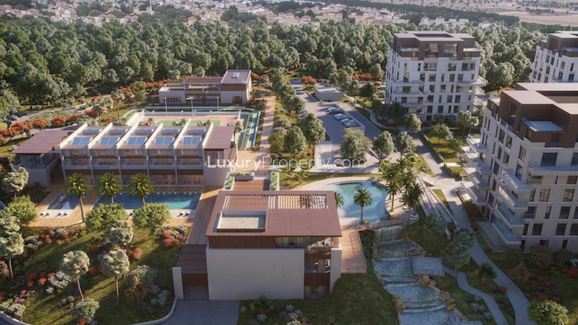 Modern apartment buildings and lush gardens in Al Barari's The Neighbourhood community