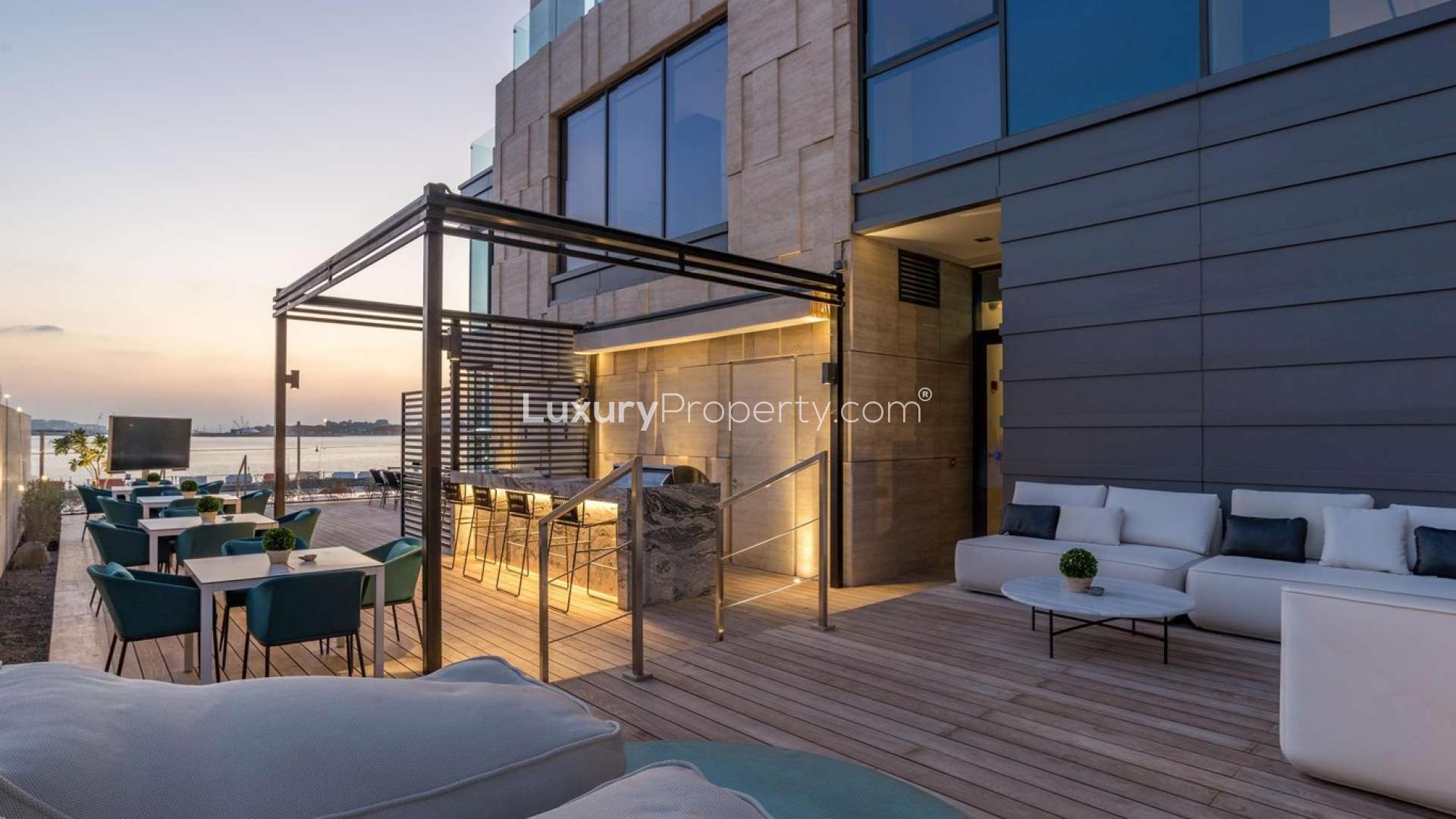 Outdoor terrace of beachfront apartment in Palme Couture, Palm Jumeirah, Dubai at sunset