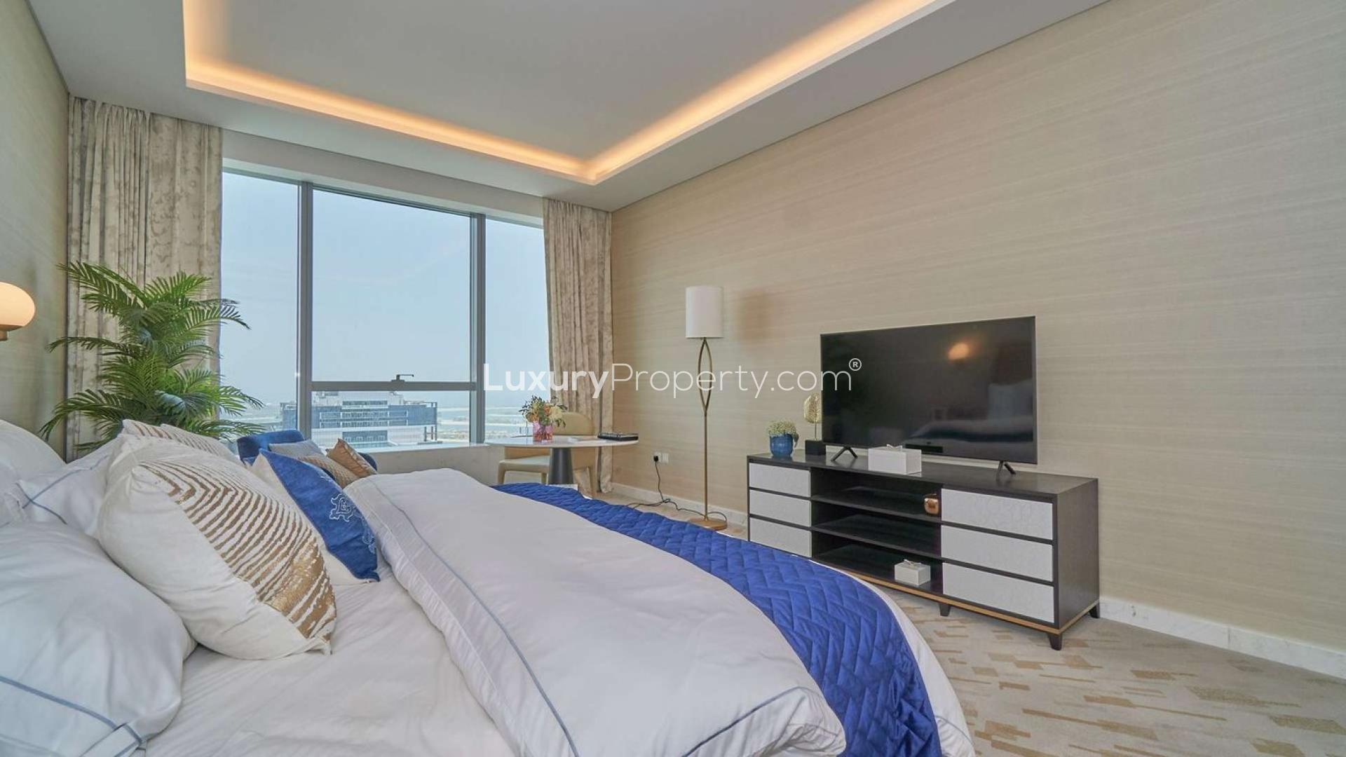 "Palm Tower exterior view, stunning studio apartment for sale, Palm Jumeirah Dubai.",Studio apartment bedroom in Palm Tower, Palm Jumeirah with modern decor and city view