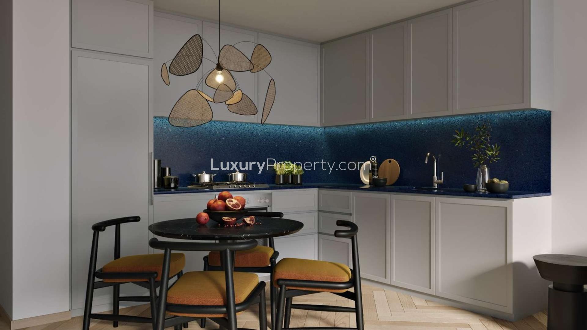 "Peninsula Three studio apartment exterior in Business Bay, Dubai waterfront skyline view.",Modern kitchen in Peninsula Three studio apartment, Business Bay, for sale