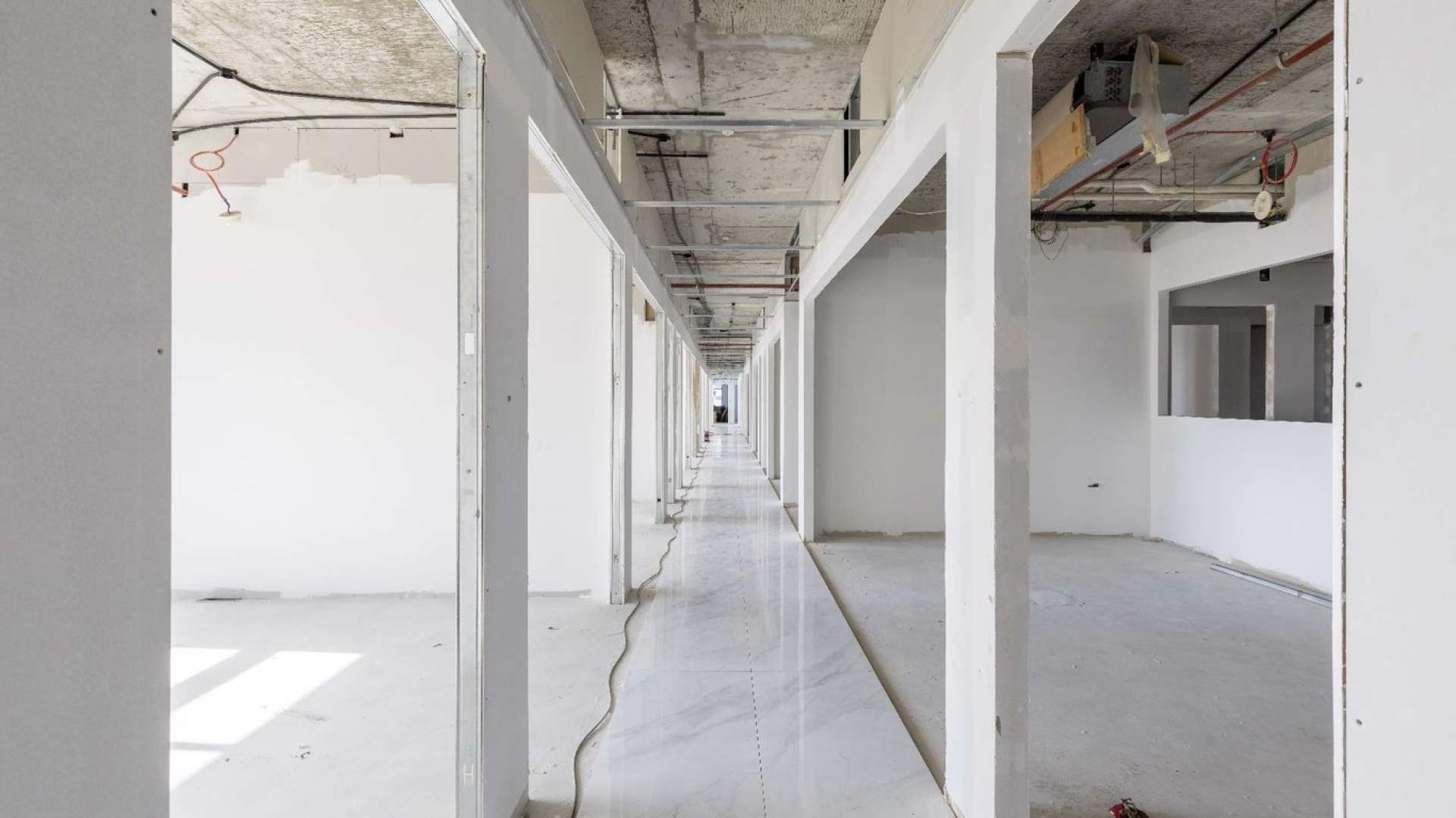 Lobby of Grosvenor Business Tower, Barsha Heights, showcasing modern design and directory board