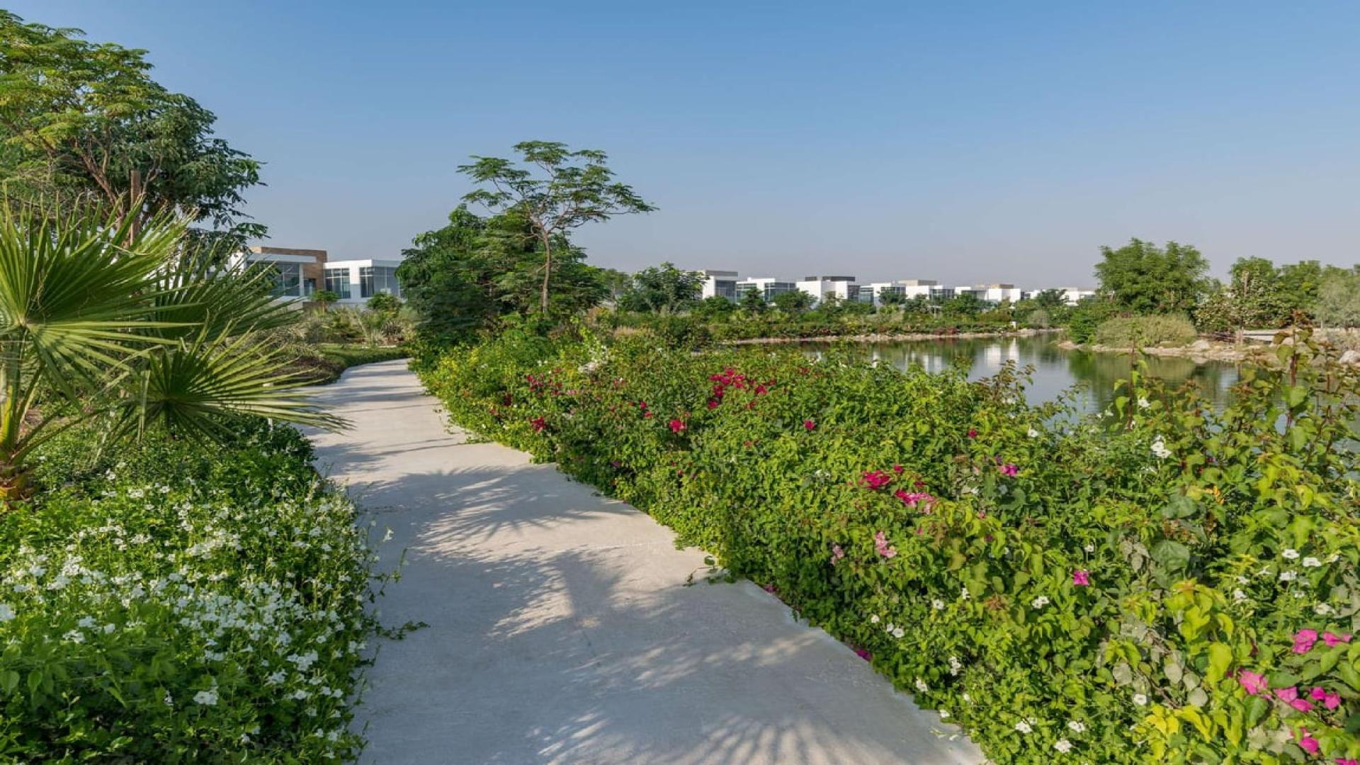 "Scenic Al Barari landscape with lush greenery and sunset view, Dubai Marina property for sale.",Scenic garden path in Al Barari, Dubai Marina residential property for sale