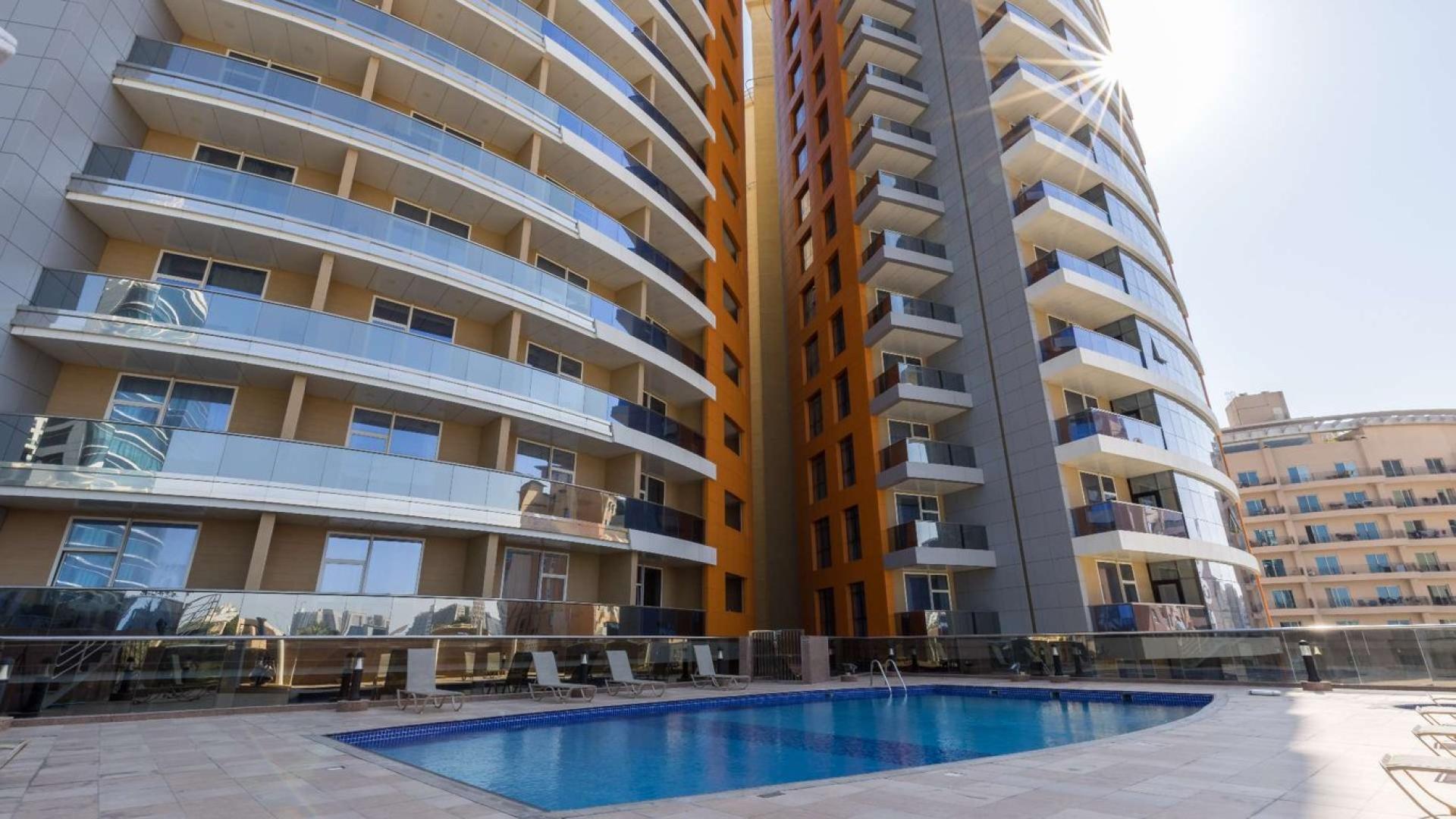 Entrance of MM Towers in Dubai Silicon Oasis, showcasing modern architecture and commercial spaces