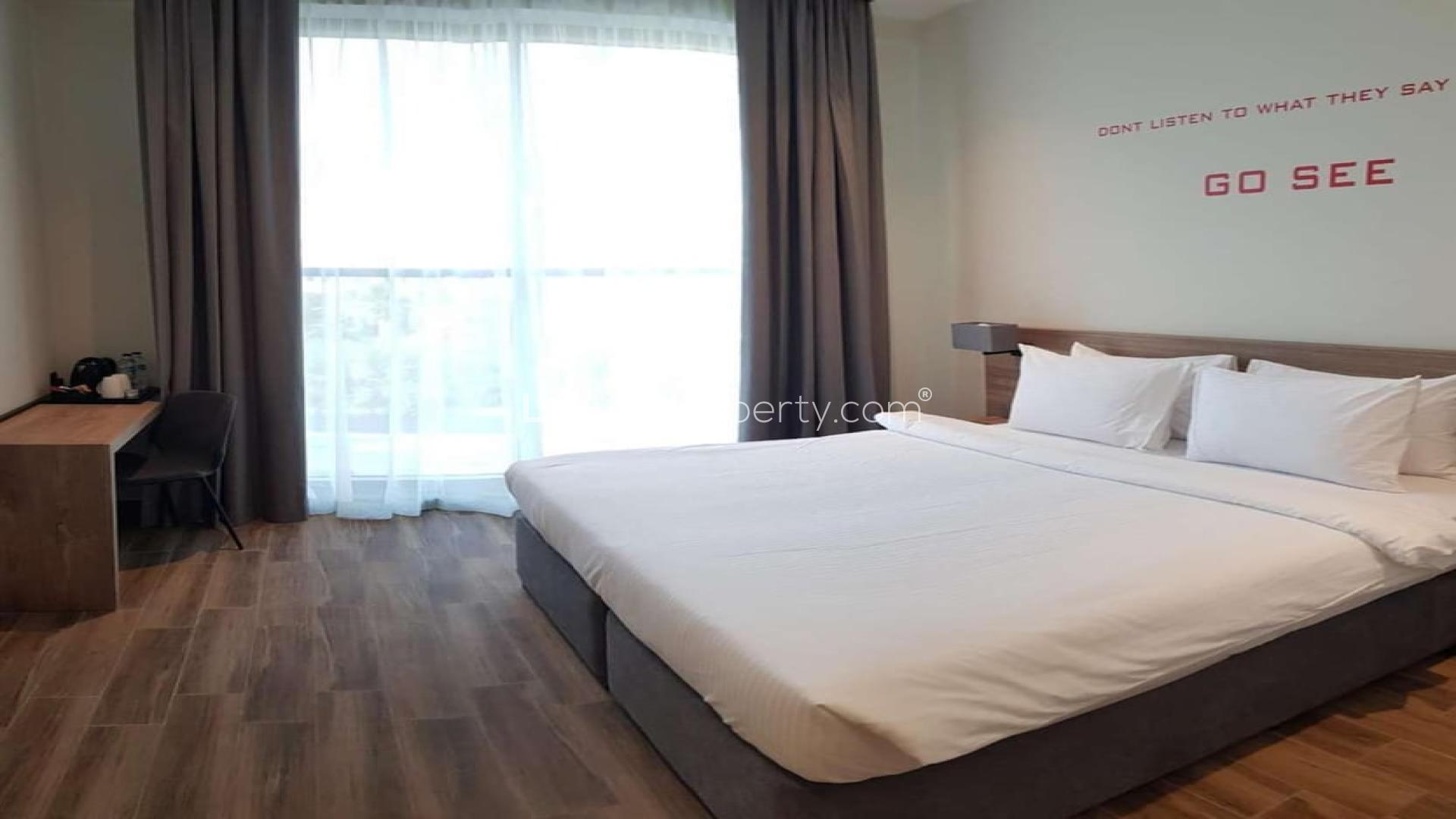 Studio bedroom in four-star waterfront hotel investment, featuring modern decor and cozy ambiance