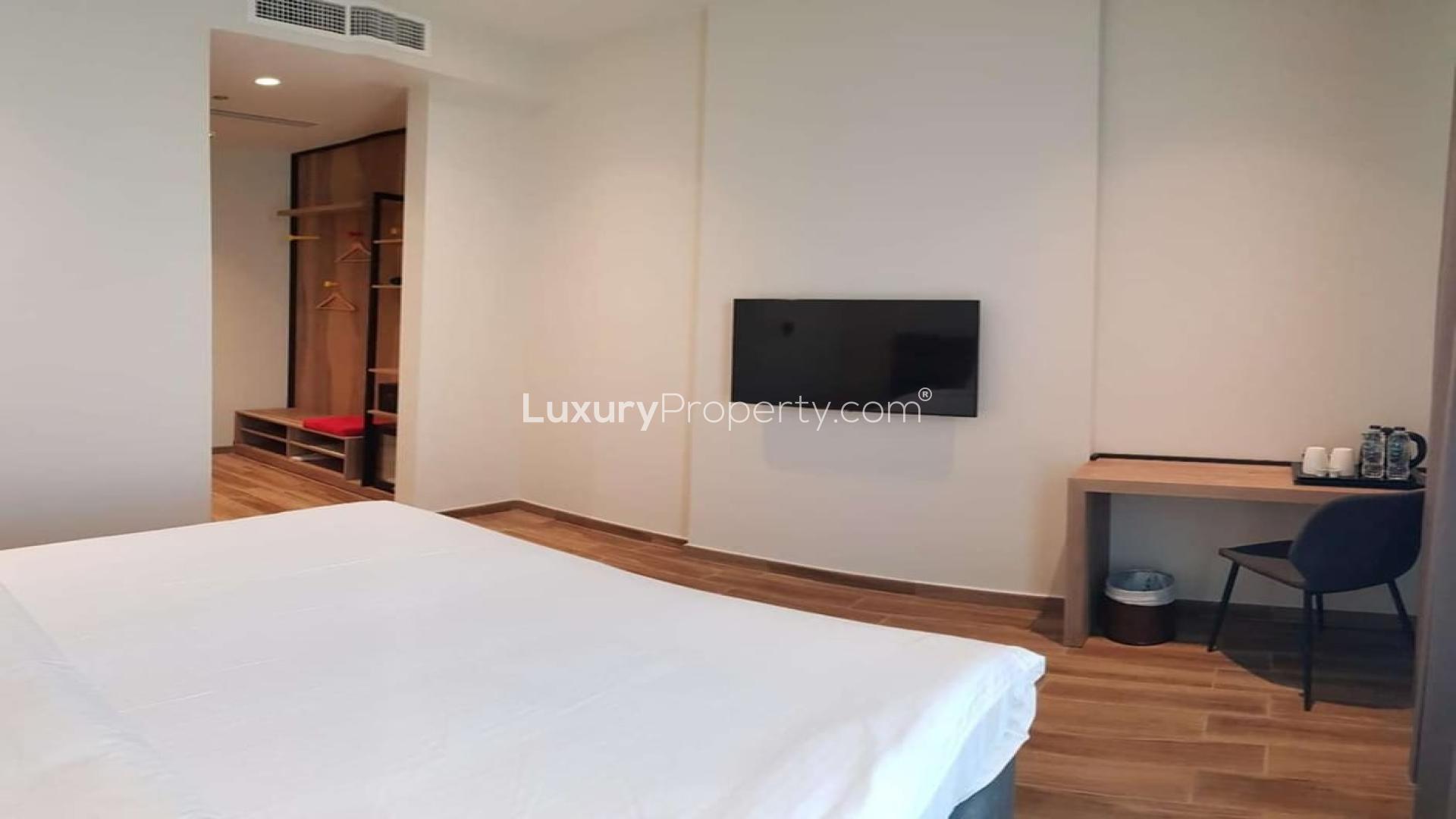 Four-star waterfront hotel exterior with modern design, available for sale. Ref No: LP06692