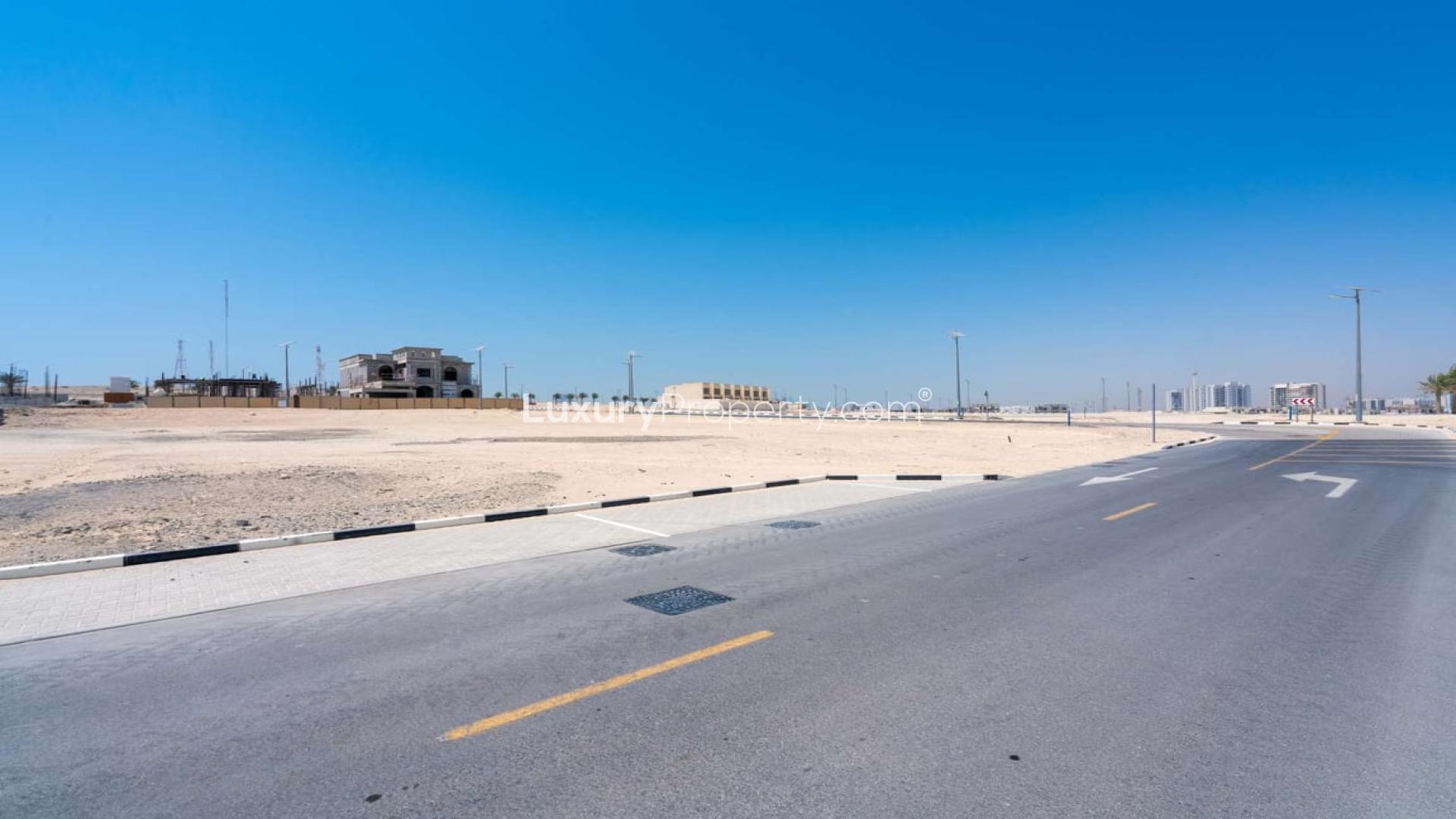 Freehold corner plot in Al Furjan's West Village, Dubai with nearby mosque and parking area