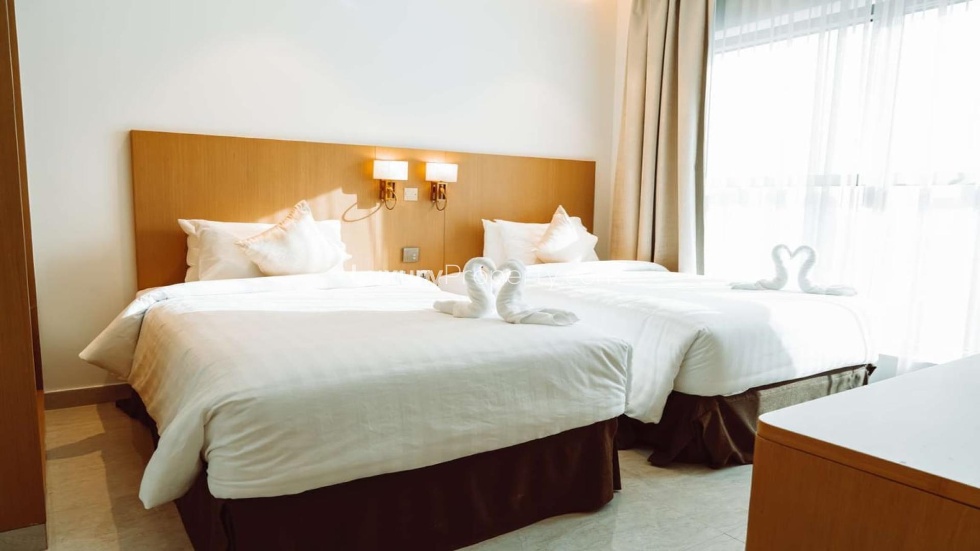 Luxurious lobby of deluxe hotel apartments with elegant seating and chandeliers for sale