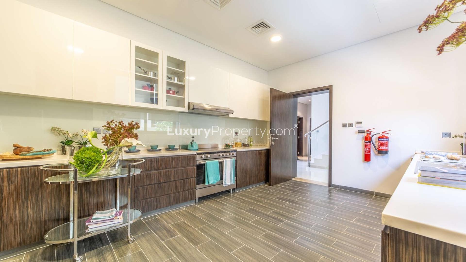 Luxurious living room in 5-bedroom villa, The Field, Dubailand with elegant decor and golf views