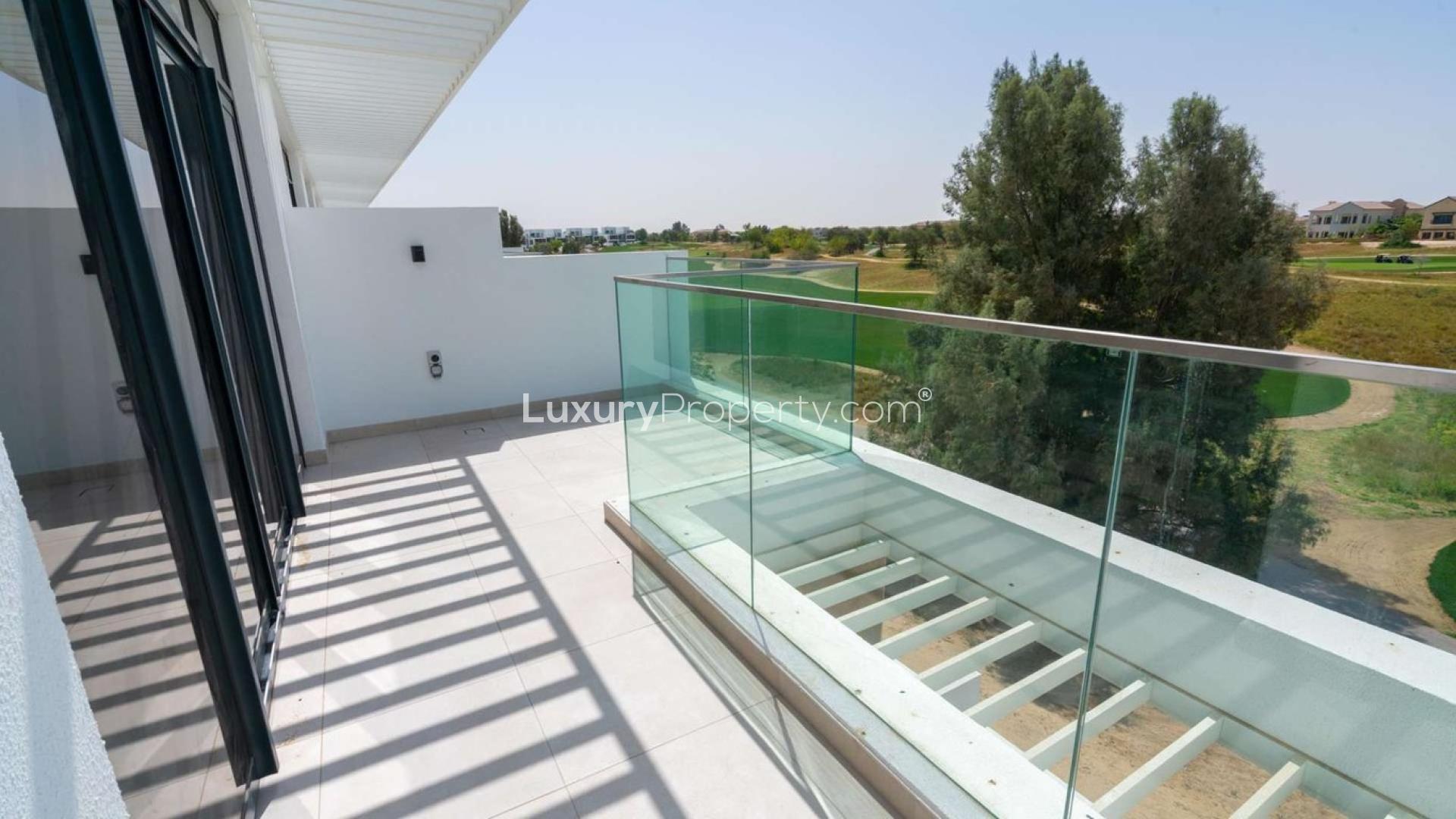 Contemporary bedroom interior with large window at Jumeirah Luxury Living townhouse for sale