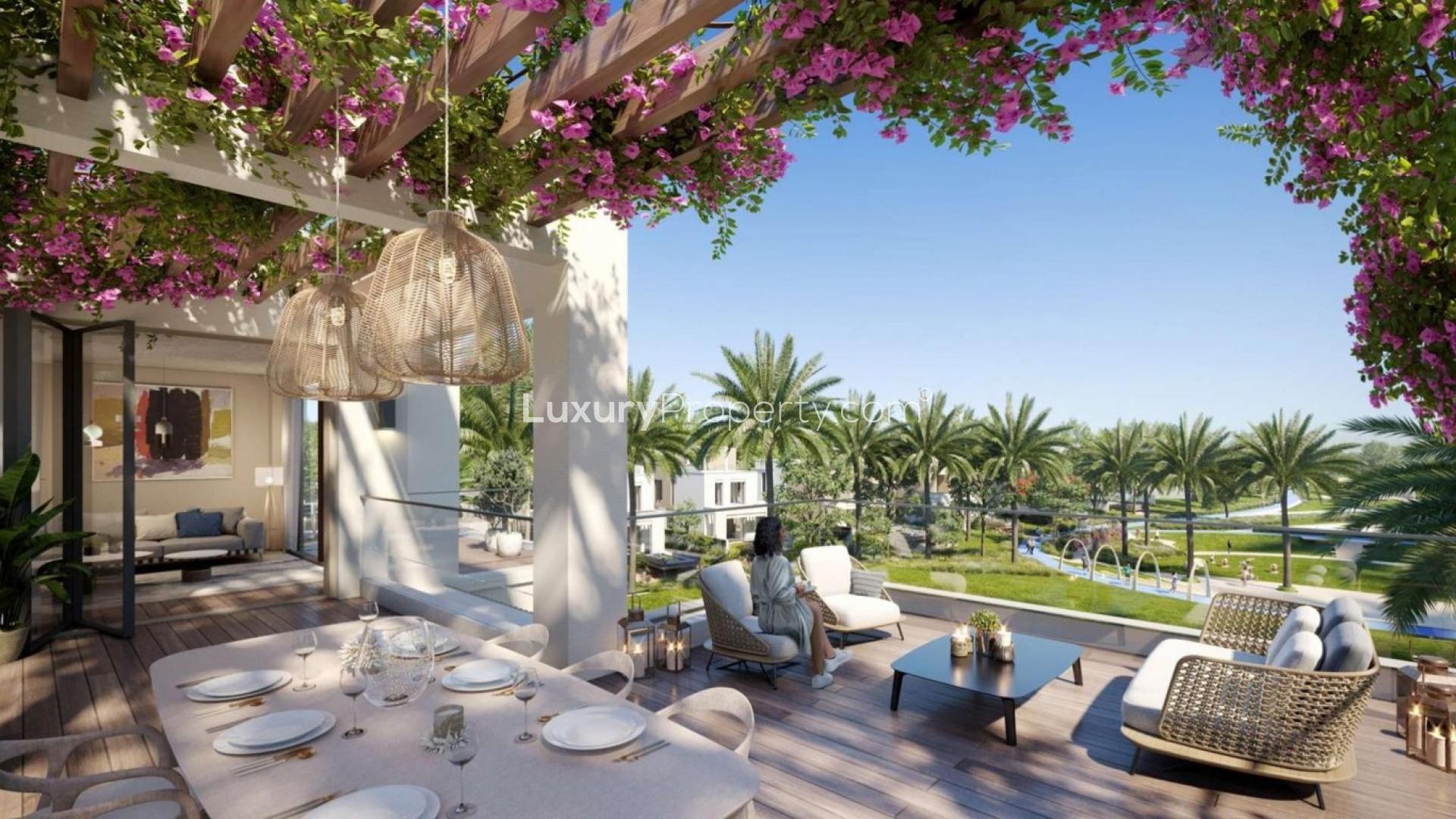 Outdoor terrace view at Caya II Villas, Arabian Ranches III, featuring lush greenery and seating