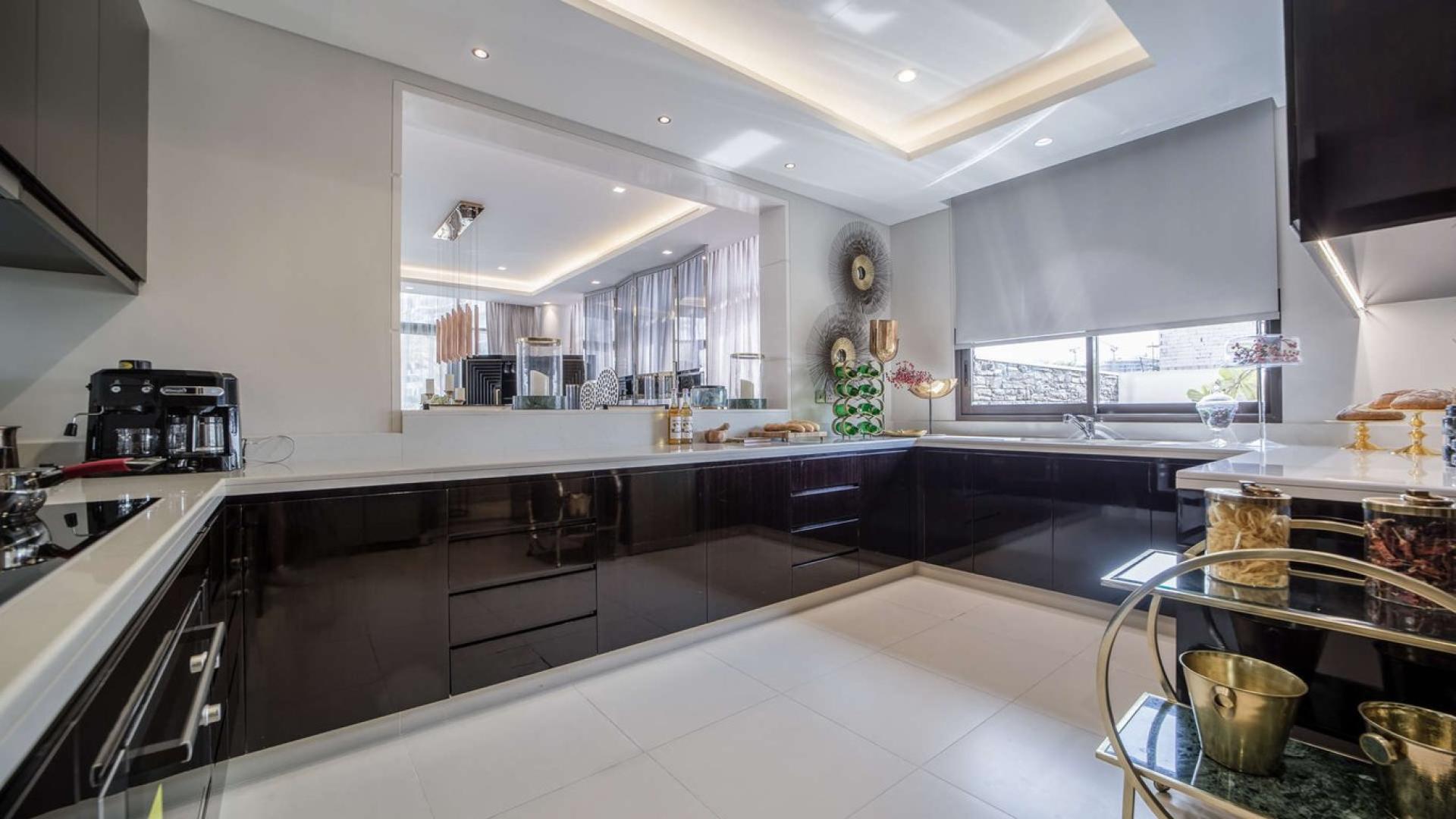 Luxurious living room in Trump Estate villa, Damac Hills, featuring elegant decor and natural light