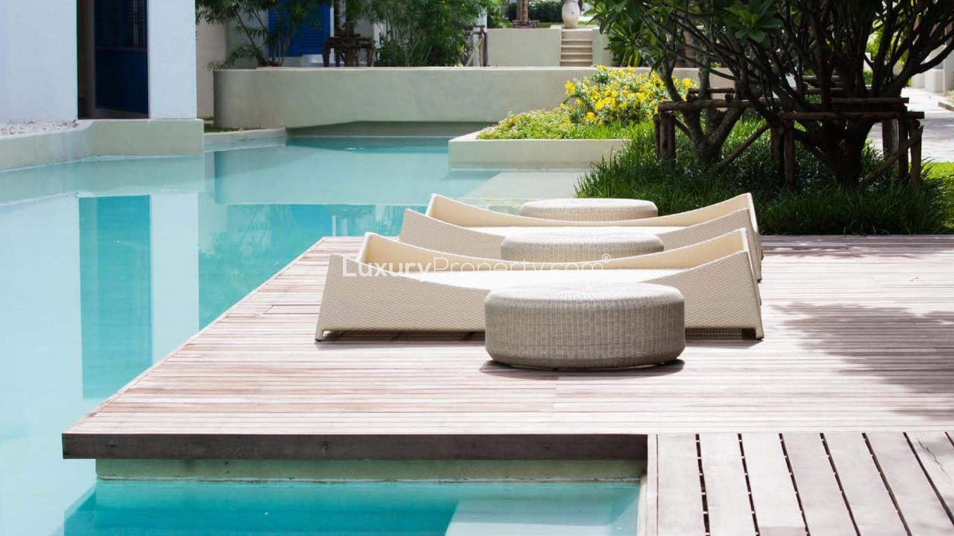 Modern Alaya Premium Villa exterior in Tilal Al Ghaf, lush greenery, two-car garage