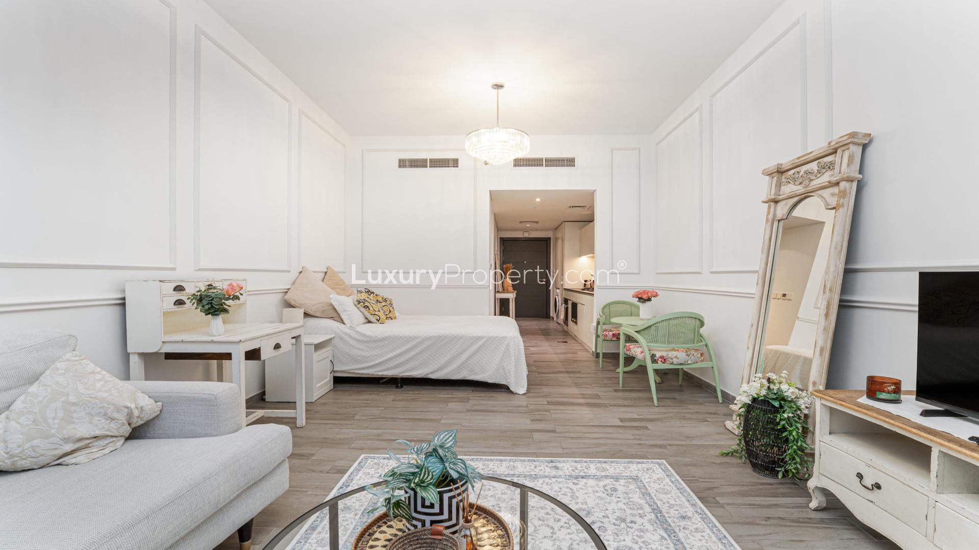 Modern studio apartment interior in Belgravia Square, JVC, featuring elegant decor and cozy furnishings