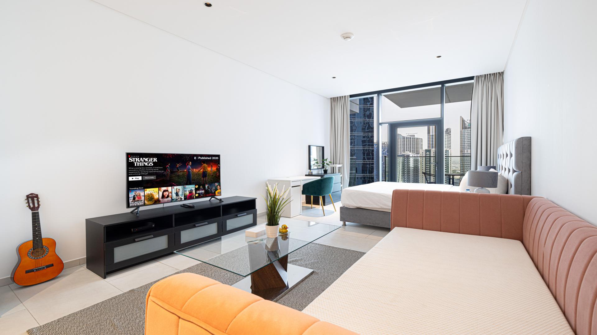 Modern studio apartment bedroom with city view in Marquise Square Tower, Business Bay