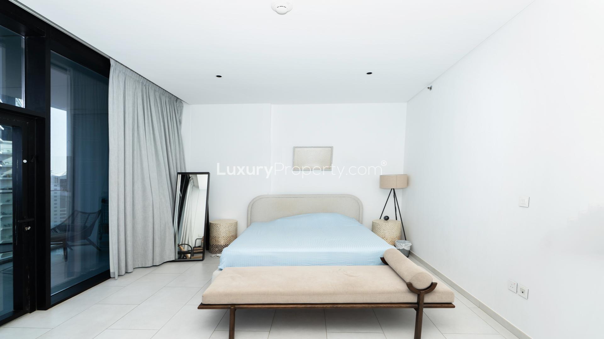Alt text: "Fully furnished studio bedroom in Marquise Square Tower, Business Bay, with canal views.",Modern kitchen in fully furnished studio, Marquise Square Tower, Business Bay apartment for rent