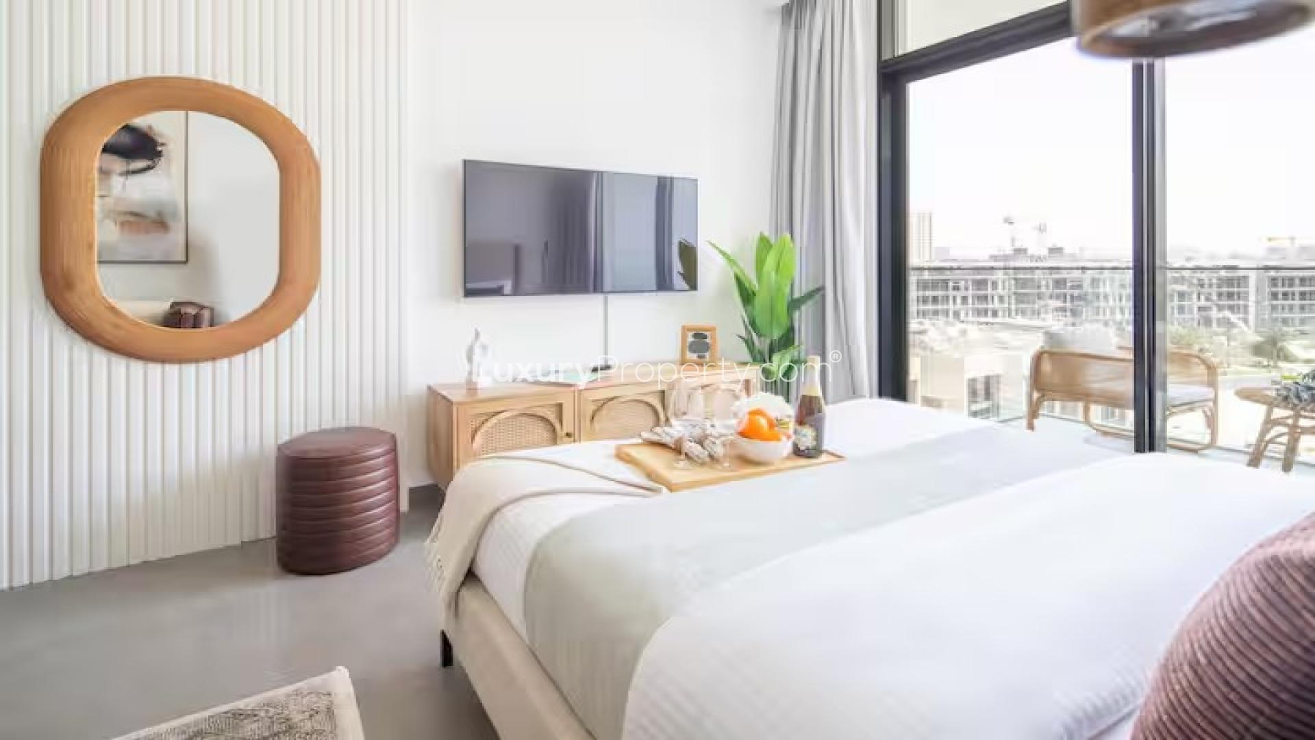 Modern bedroom with balcony view in Jumeirah Village Circle apartment, District 11