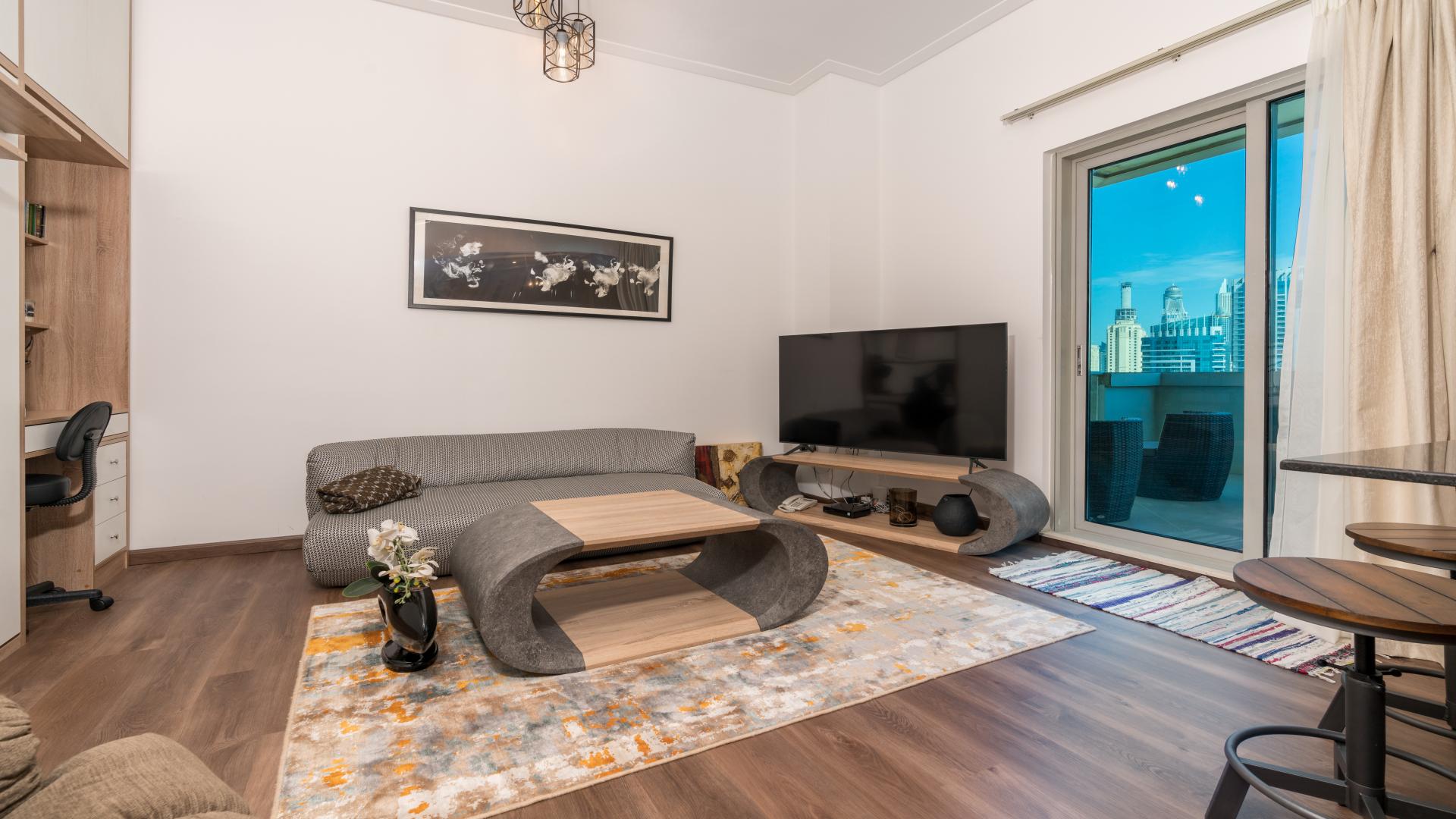 Balcony view from luxurious studio in Paloma Tower, Dubai Marina, overlooking skyscrapers and sea