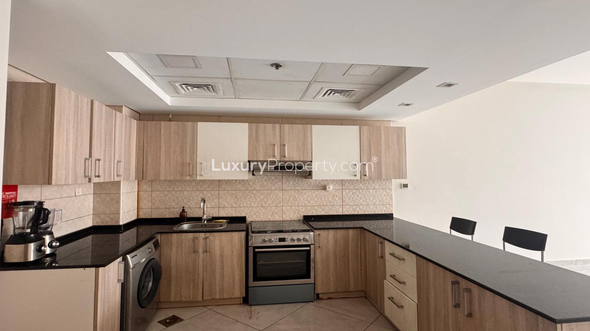 Modern kitchen in Jumeirah Village Circle studio apartment, Chaimaa Premiere, available for rent