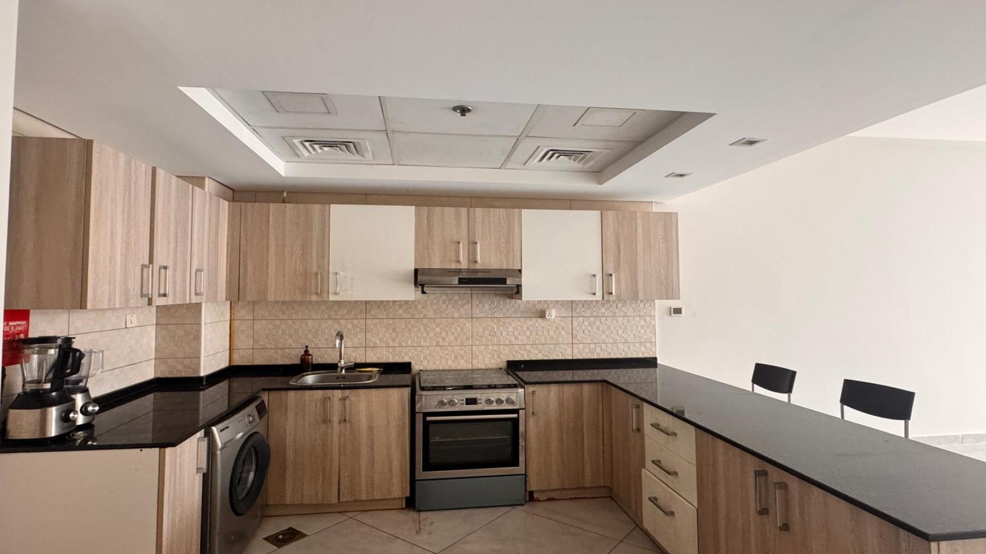 Modern kitchen in Jumeirah Village Circle studio apartment, Chaimaa Premiere, available for rent