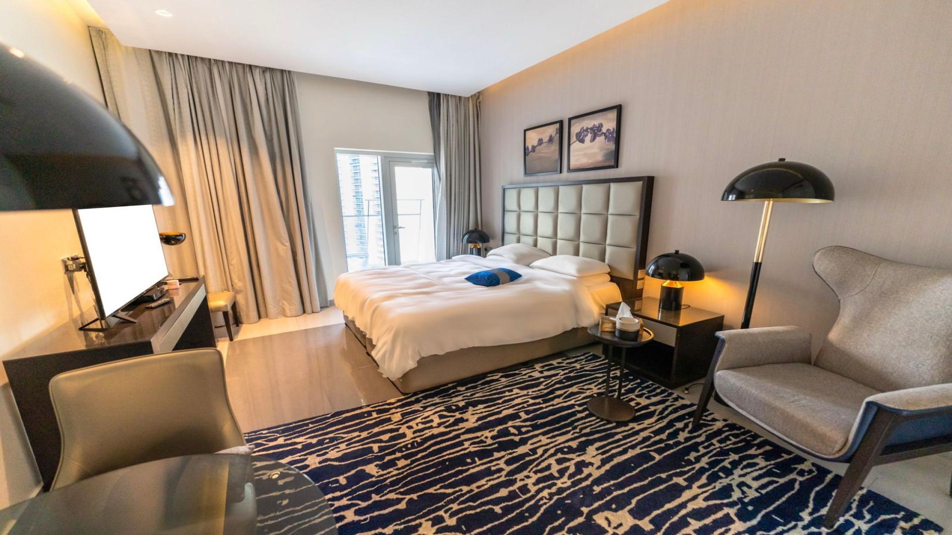 High-floor studio apartment in DAMAC Majestine, Business Bay, featuring modern furnishings and decor